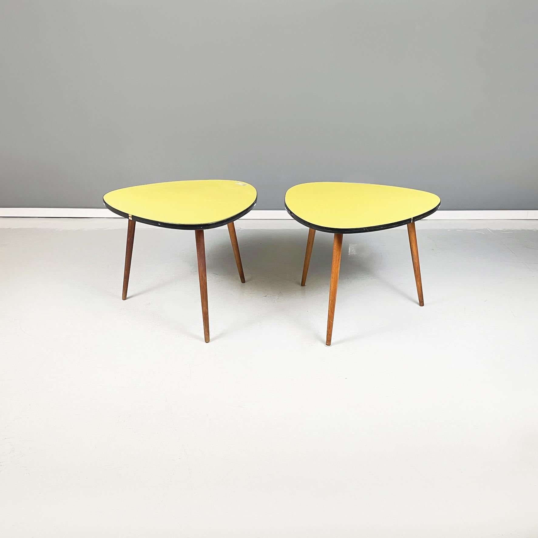 Northern European mid-century wood, yellow and black formica coffee tables, 1960s
Pair of coffee tables with triangular top with rounded corners, in yellow formica and black profile. The legs of the table have a round section in solid beech