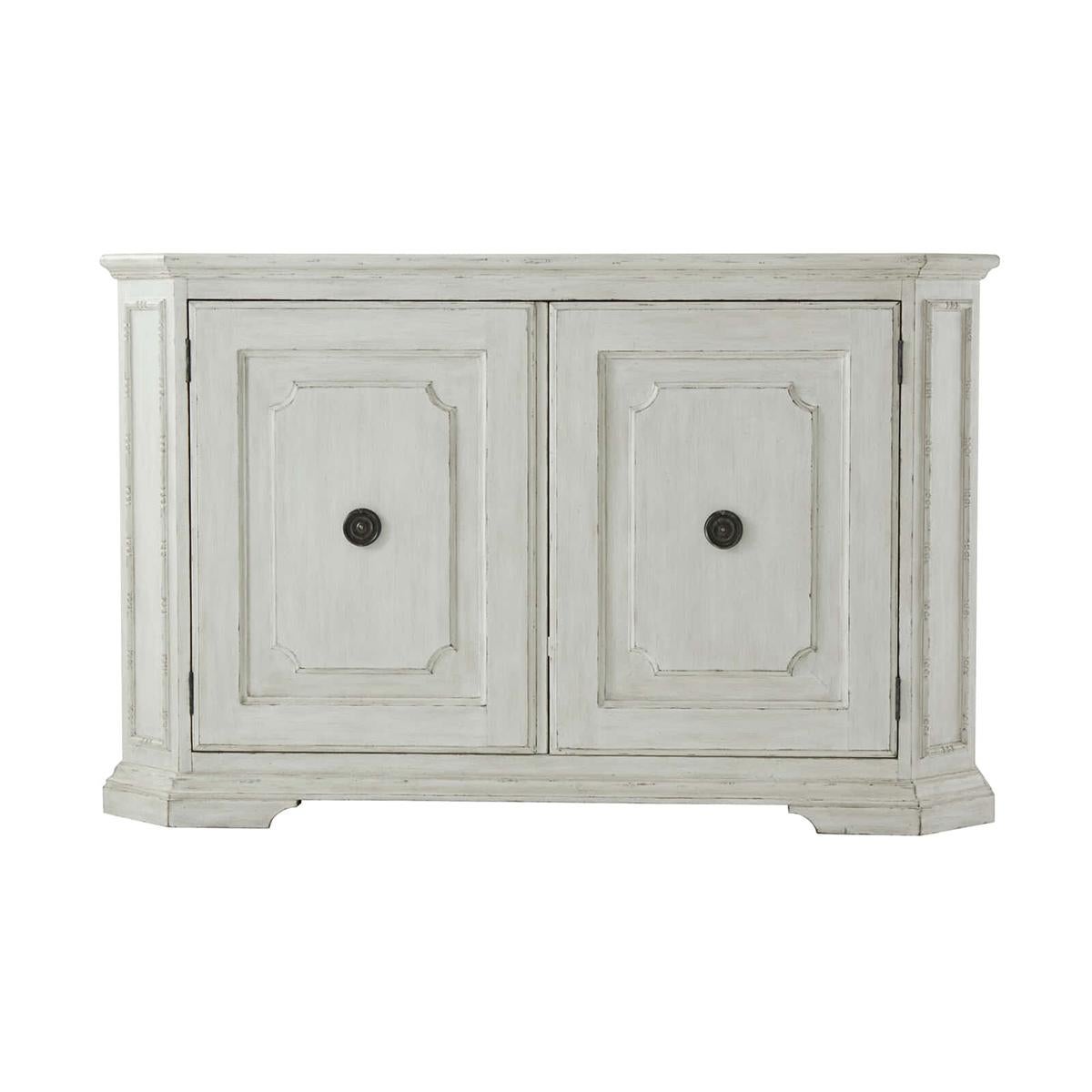 Northern European painted buffet with a rectangular top having canted corners with paneled and angled uprights, two cabinet doors, the interior with two adjustable shelves and raised on molded bracket feet.

Dimensions: 65