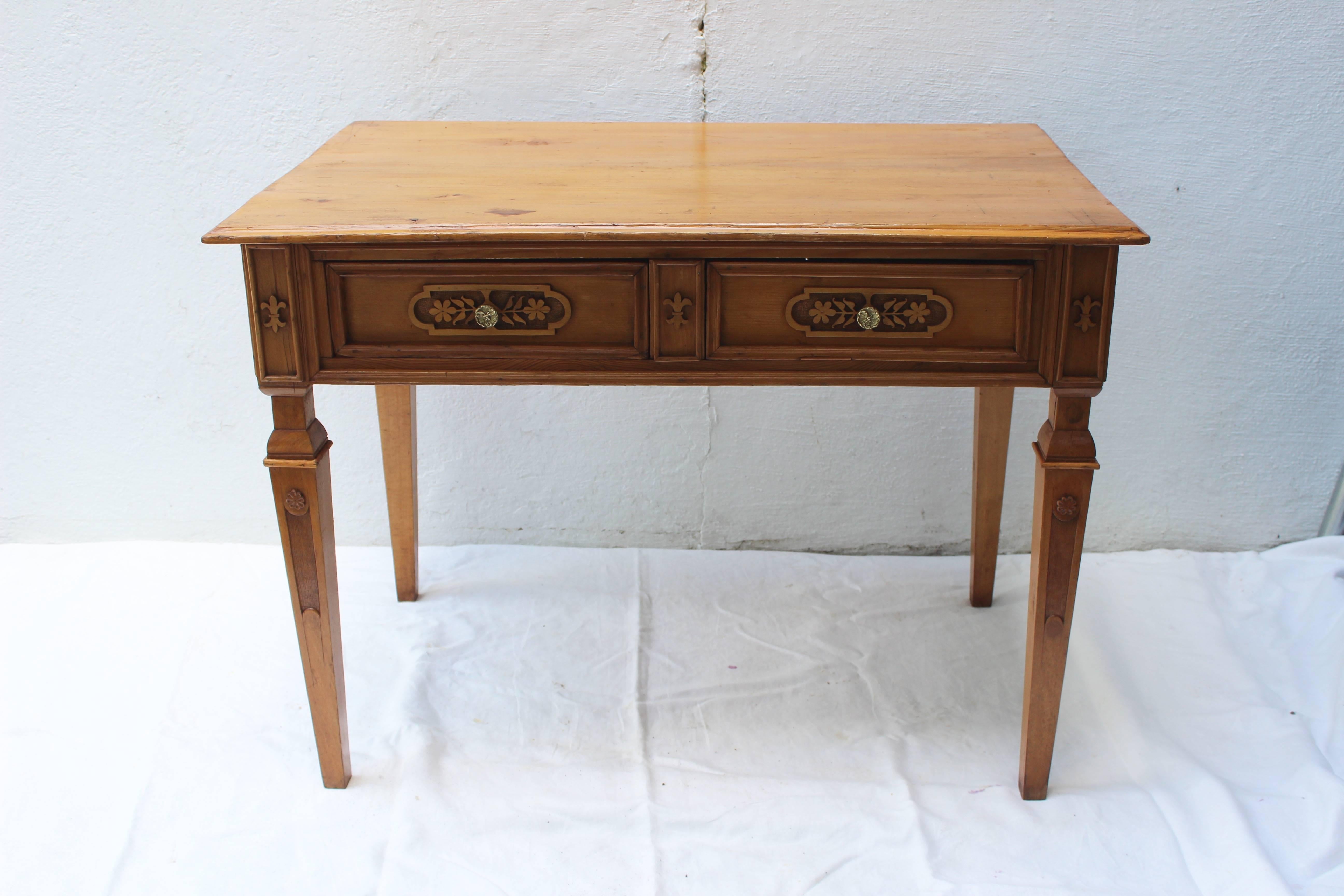 Two-part northern European pine desk with two upper cabinets with carved cornice and panelled door resting on a desk with two drawers all supported on tapered legs, circa 1900.

The table is 29.25