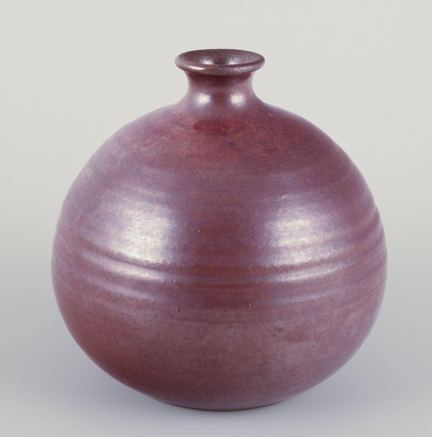 Pre-owned goods are exempt from import duties for U.S. customers. 
Therefore, no import tariffs will be applicable to your purchase.

Northern European studio ceramicist.
Ceramic vase with a round classic shape.
Shiny glaze in brown hues.