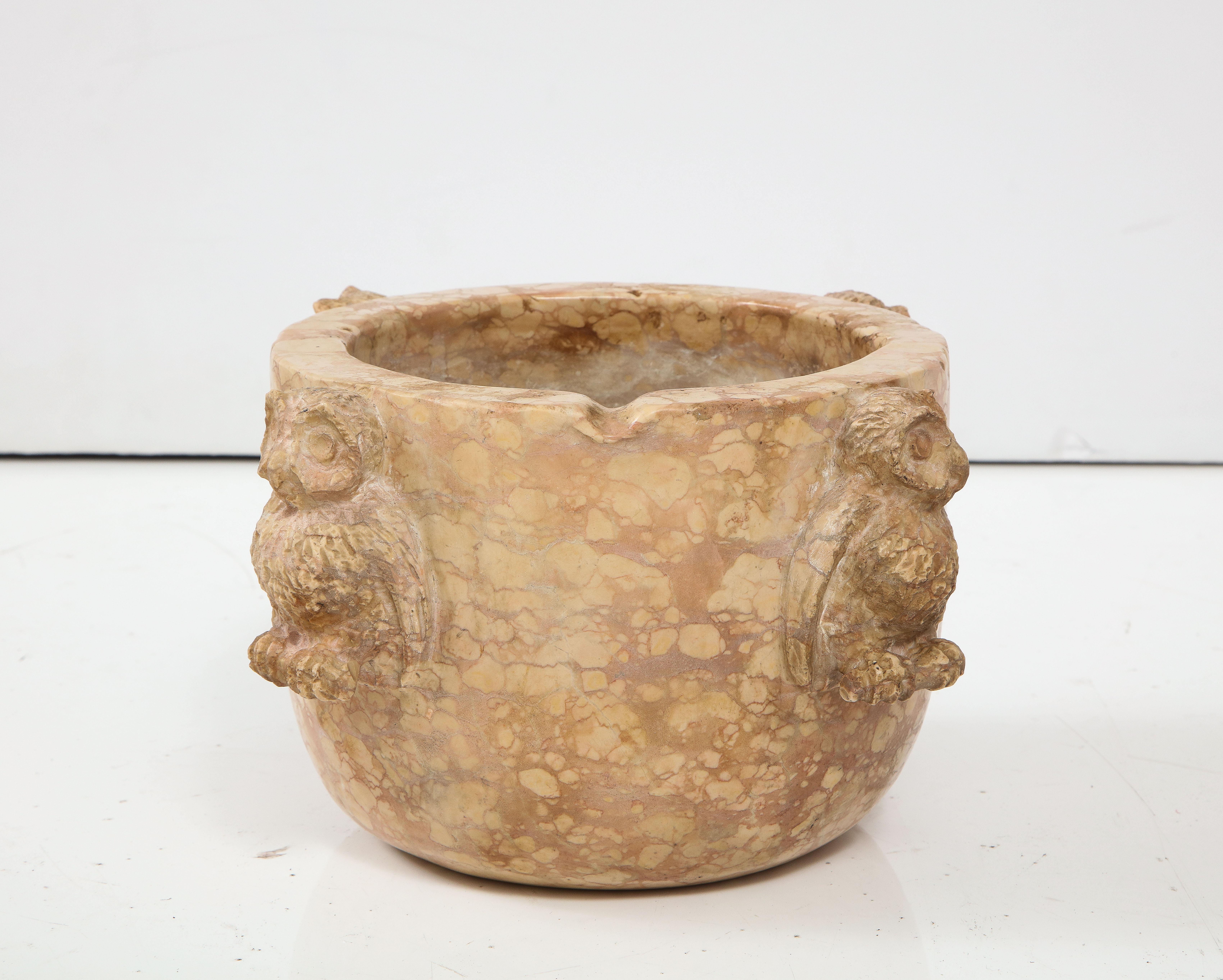 This uniquely beautiful Northern Italian mortar was carved from a solid block of Breccia marble. On each of the sides are four fancifully and intricately carved charming and expressive owls. This is a wonderful example of an everyday object made