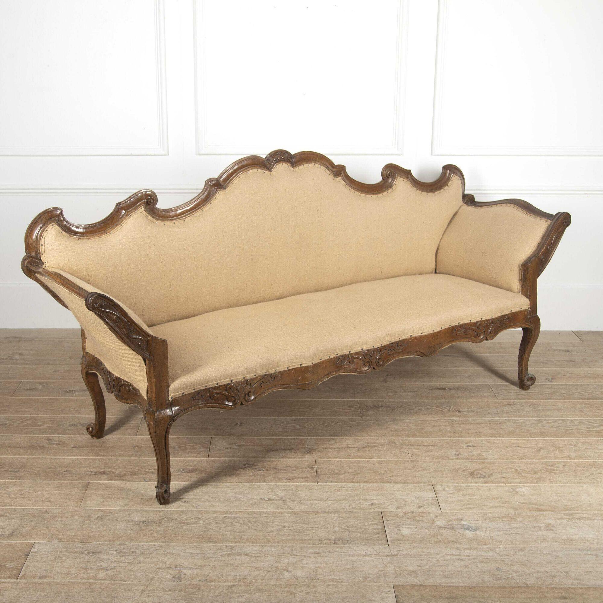 Wonderful northern Italian 18th century walnut sofa. 
This sofa has a fantastic intricately hand-carved frame in the romantic rococo style. With outswept arms and raised on cabriole legs. 
This sofa has been restored and reupholstered in hessian.