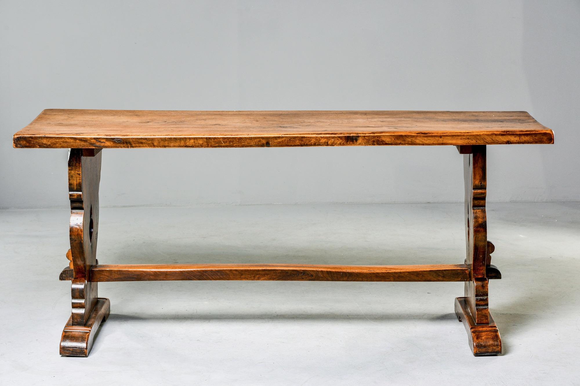 Walnut trestle table from Northern Italy with decorative carved detail on side supports and mortise and tenon construction, circa 1850s. Measure: Apron height 28.75”. Honest wear, marks and patina to wood. See detail photos. Unknown maker.

 