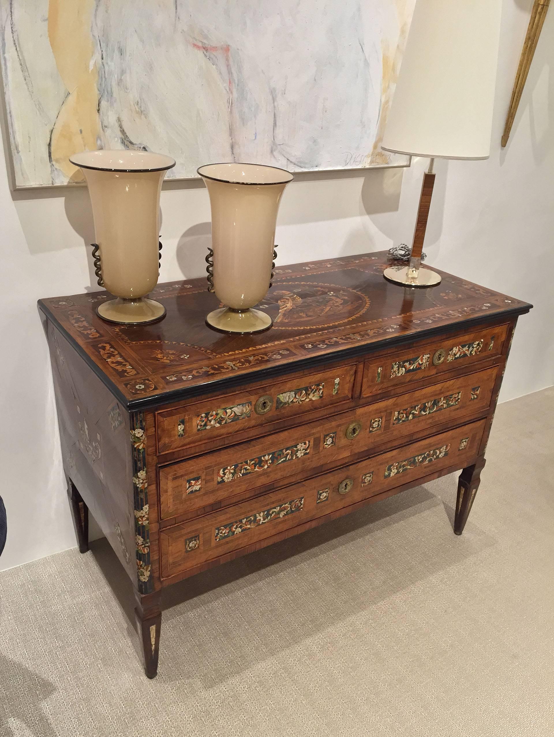 Northern Italian circa 1785 neoclassic marquetry commode having an intricately inlaid top with lacquer, fruitwoods and mother-of-pearl showing a central parrot, the front with two short drawers and two long similarly inlaid, as well as, the sides.
 