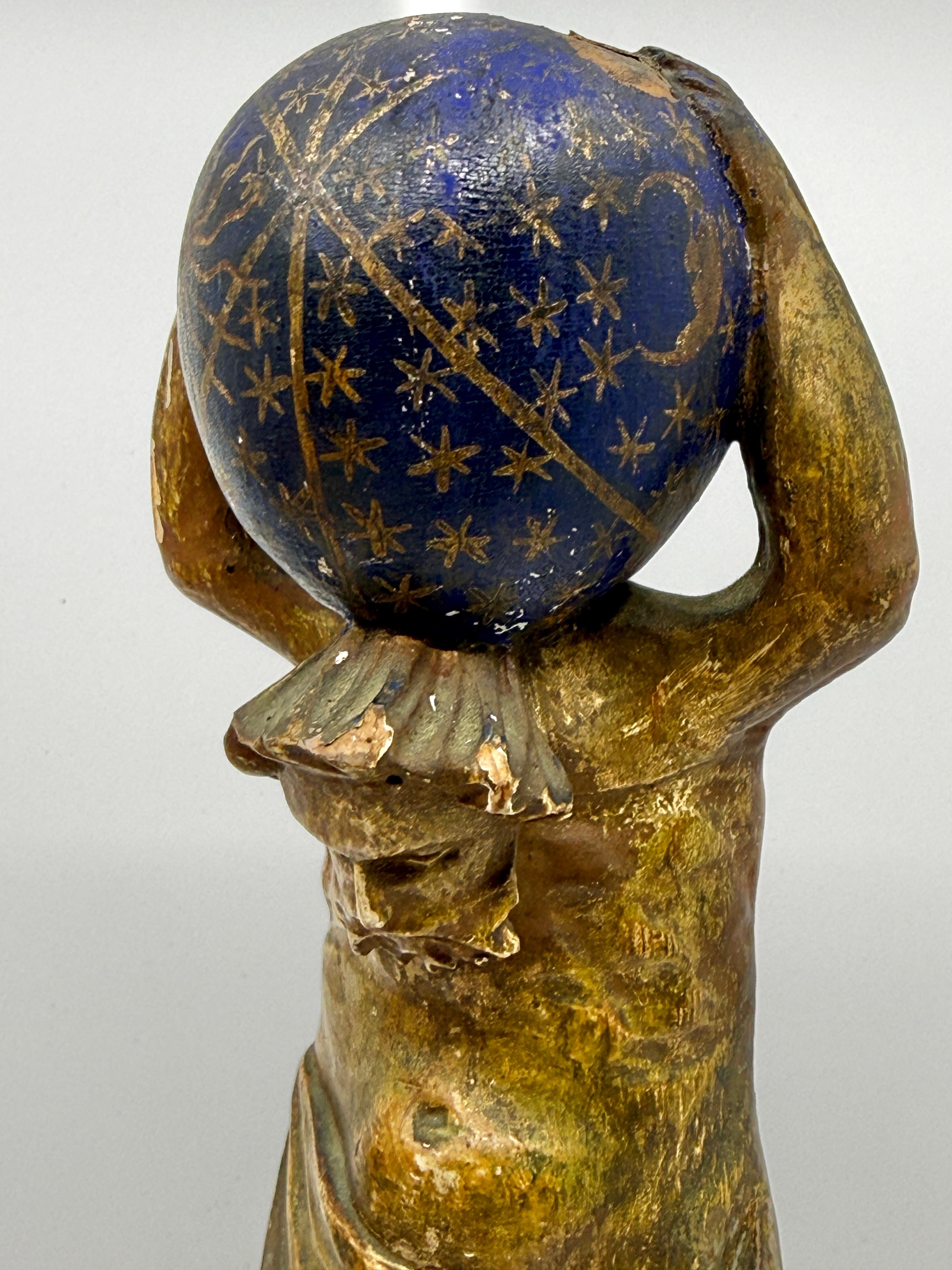 Rare late 18th–early 19th century carved wooden figure of Atlas supporting a celestial sphere, Northern Italy (Venice or Padua), circa 1780–1820.
This beautifully modeled figure is carved in wood with its original gesso, polychrome, and parcel-gilt