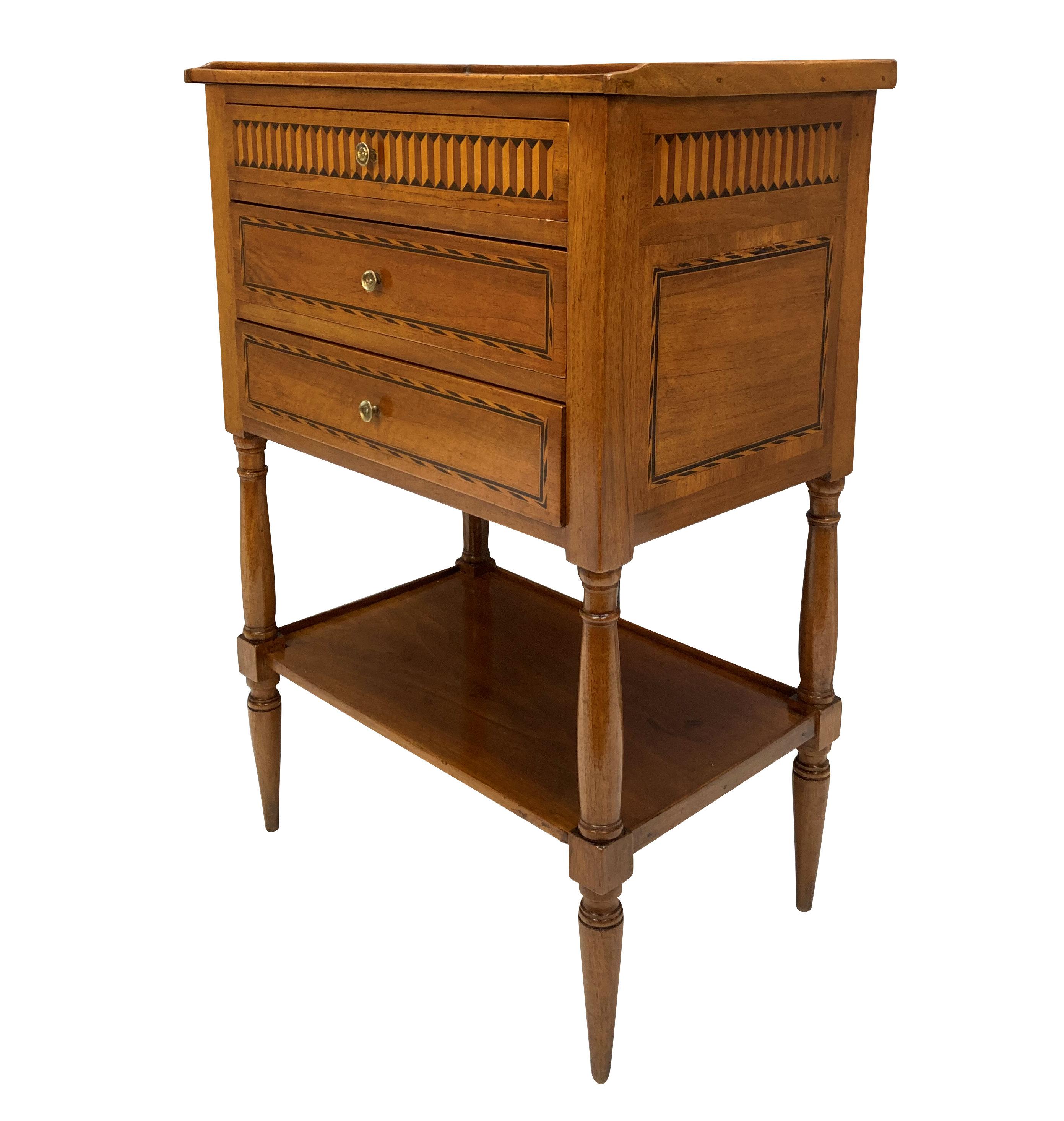 A Northern Italian, late XVIII Century night stand in walnut and various inlays. With a galleried top, three drawers and a bottom shelf.