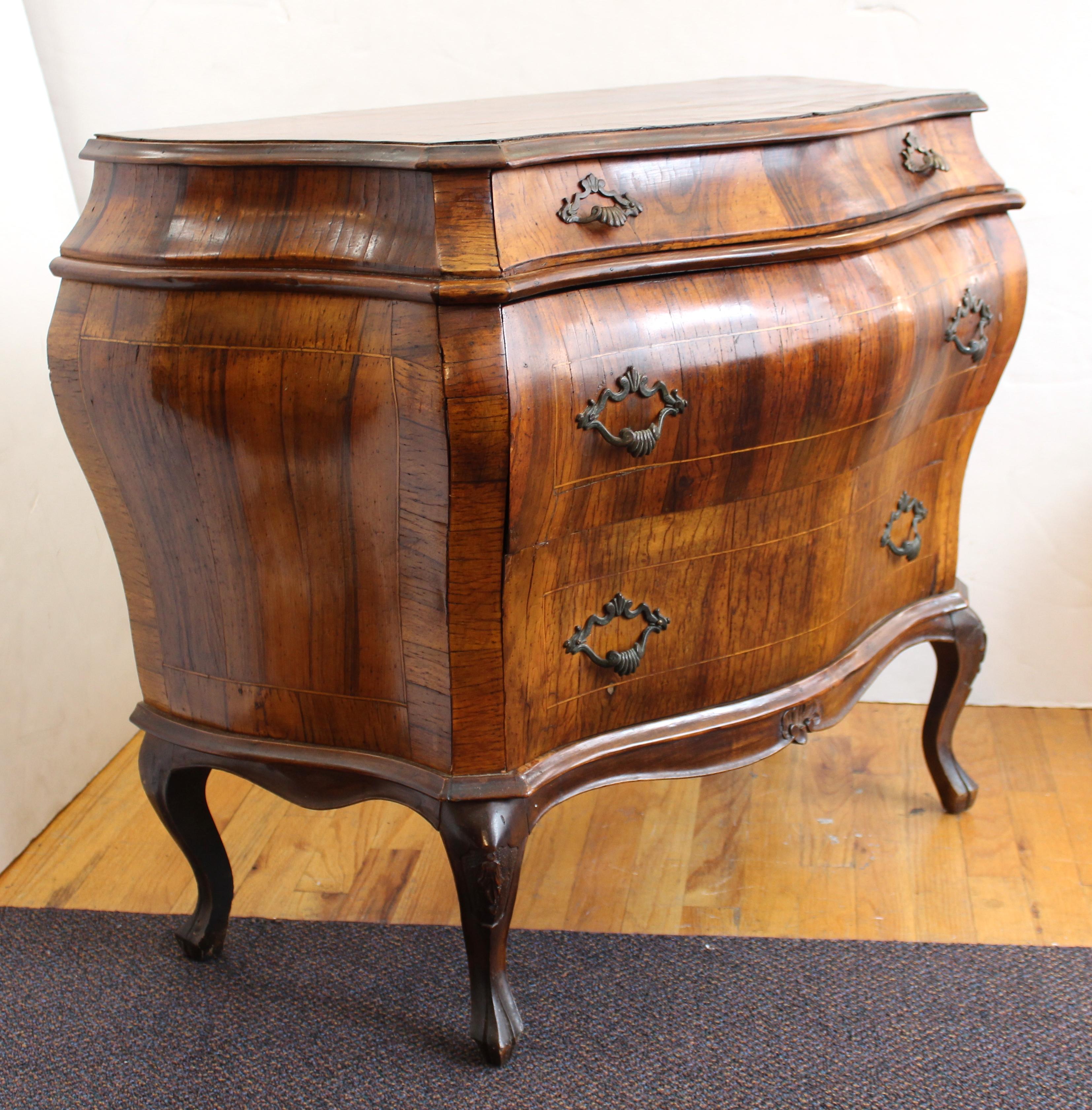 Northern Italian Rococo manner bombe commode in fruit-wood inlay, with two small drawers over two rows of long drawers and cabriole legs. The piece is in good antique condition and was made in the early to mid-19th century. The piece shows some age