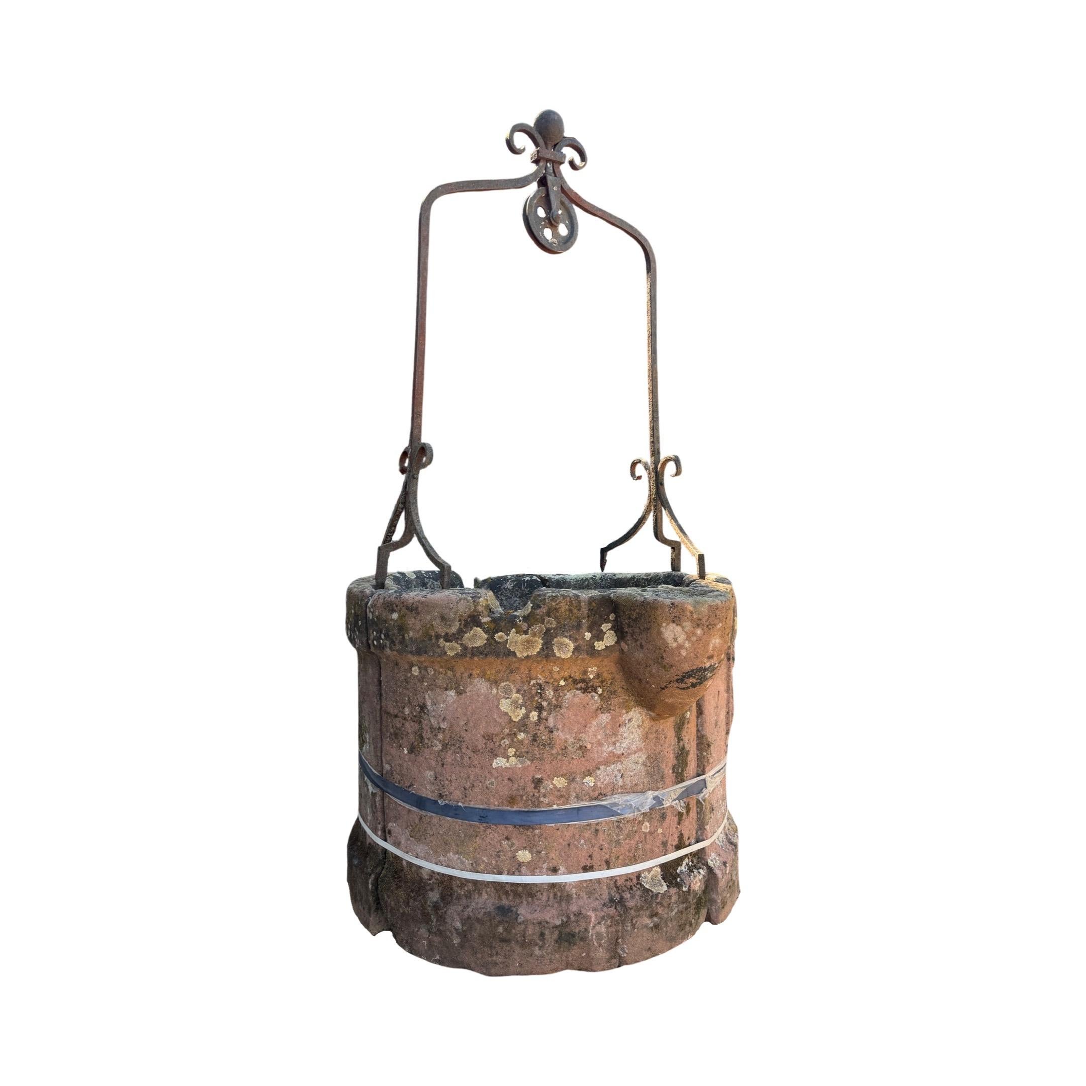This unique 16th-century Northern Italian well features an impressive limestone base and an iron-top structure. It also includes a stunning carved coat of arms symbol engraved on its outside wall, making it a perfect statement piece for any