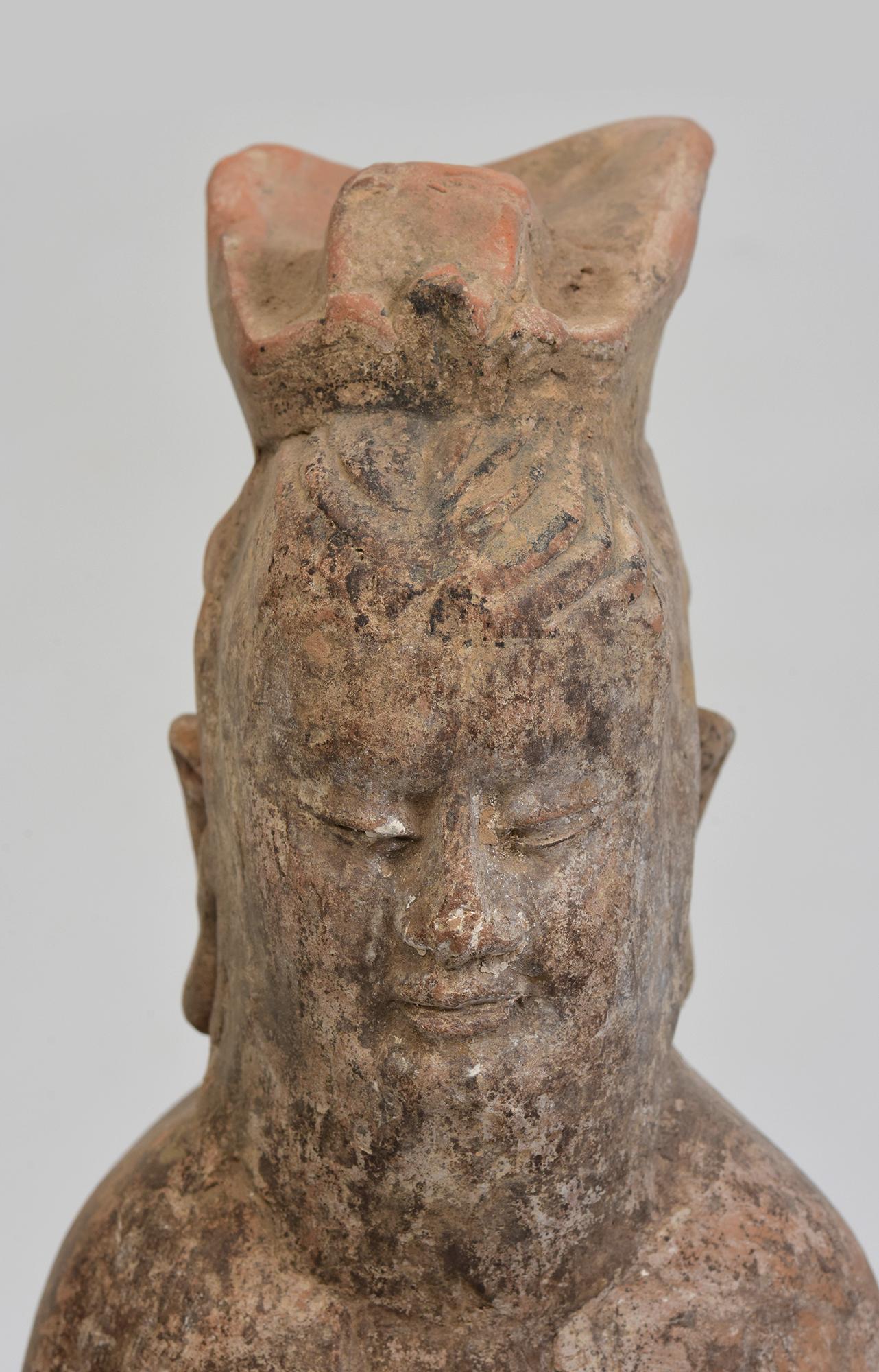 Antique Chinese pottery standing court man.

Age: China, Northern Qi Dynasty, A.D. 550 - 577
Size of figure only: Height 29.8 C.M. / Width 9 C.M.
Height including stand: 33.8 C.M.
Condition: Well-preserved old burial condition overall with some