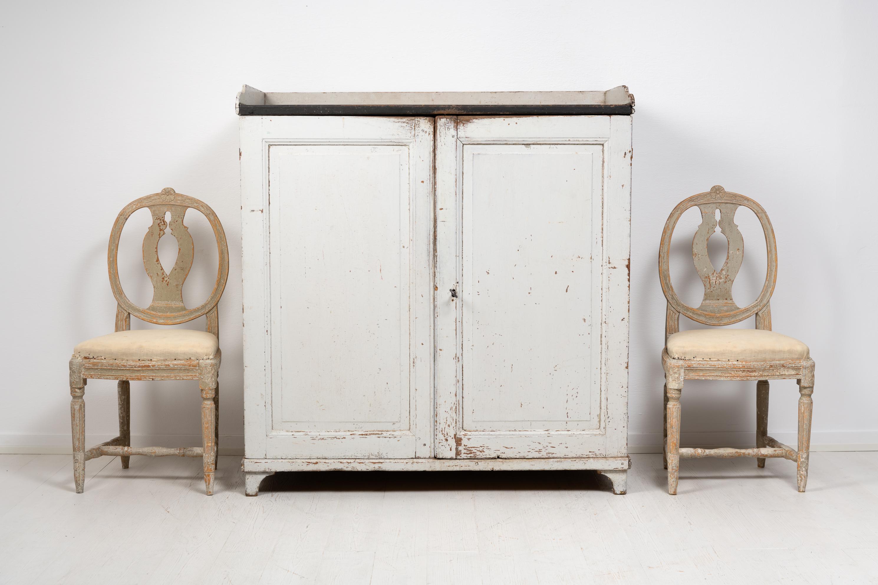 Swedish country furniture sideboard in folk art from northern Sweden. The sideboard is from the early 1800s, likely the years around 1810 to 1820. It’s painted pine and in the untouched original condition with paint from the mid 1800s. There are