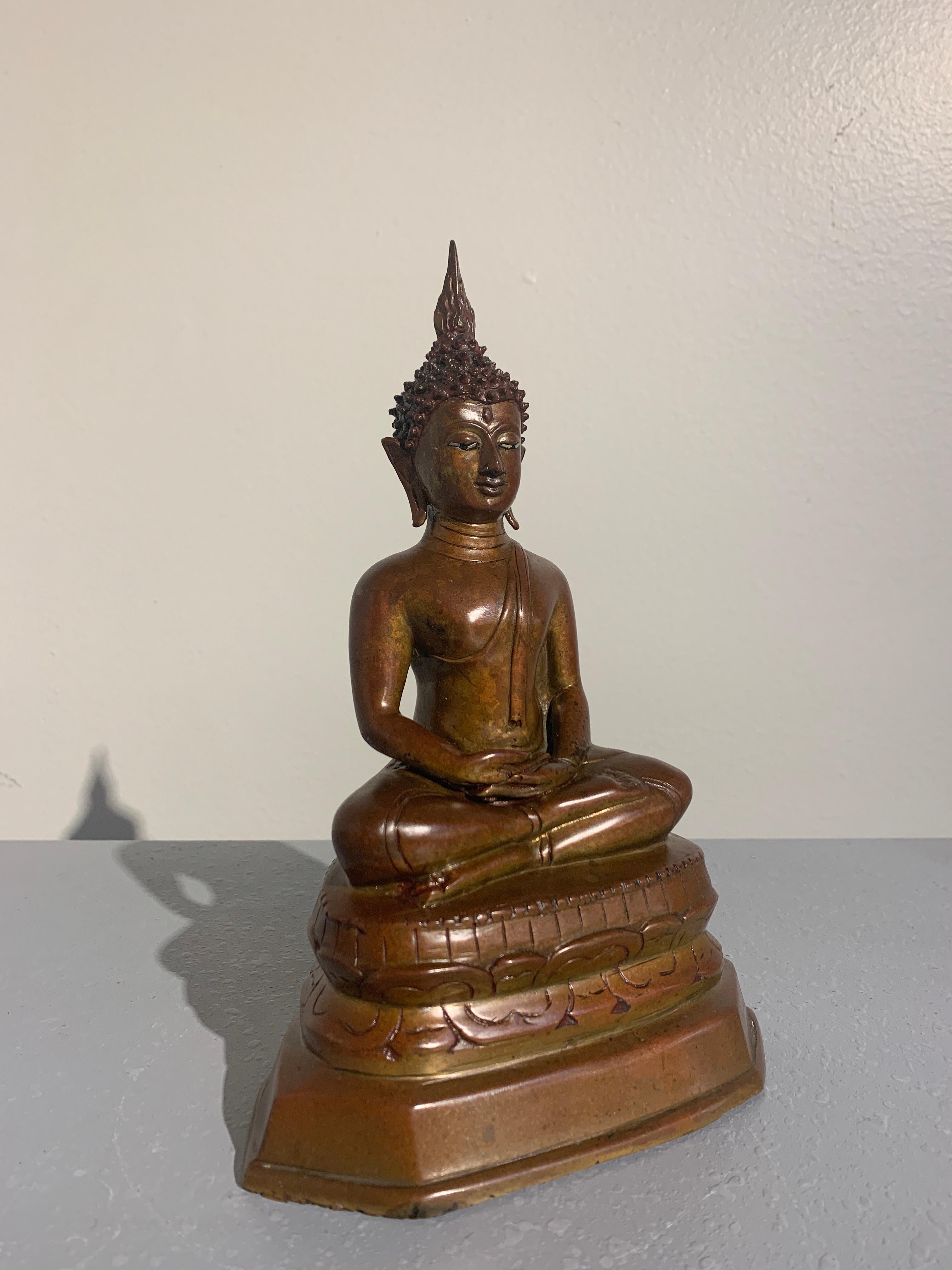 A lovely northern Thai cast bronze seated meditating Buddha statue with shell inlaid eyes, style of Wat Chedi Luang, Lan Na Kingdom, region of Chiang Mai, 15th-16th century. 

The statue of the historical Buddha, Shakyamuni, is portrayed in