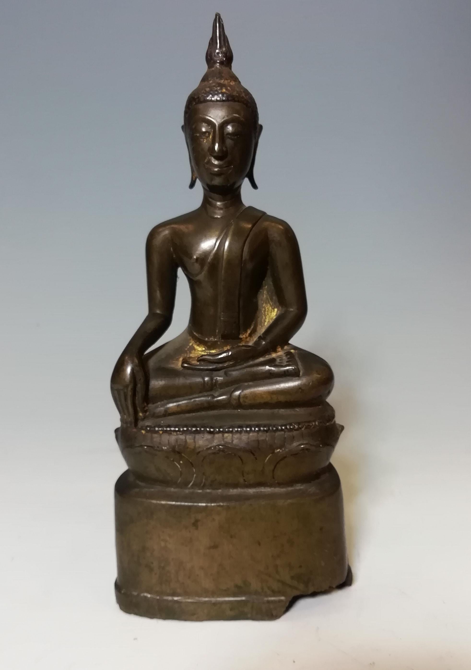 A northern Thai Lanna period bronze Buddha 

The finely cast bronze alloy figure Buddha seated in Bhumisparsa mudra, 

Showing traces of old gilt on body and back of head, 

Period: 18th century or earlier. 

Ex UK collection, 

Measures: Height 23