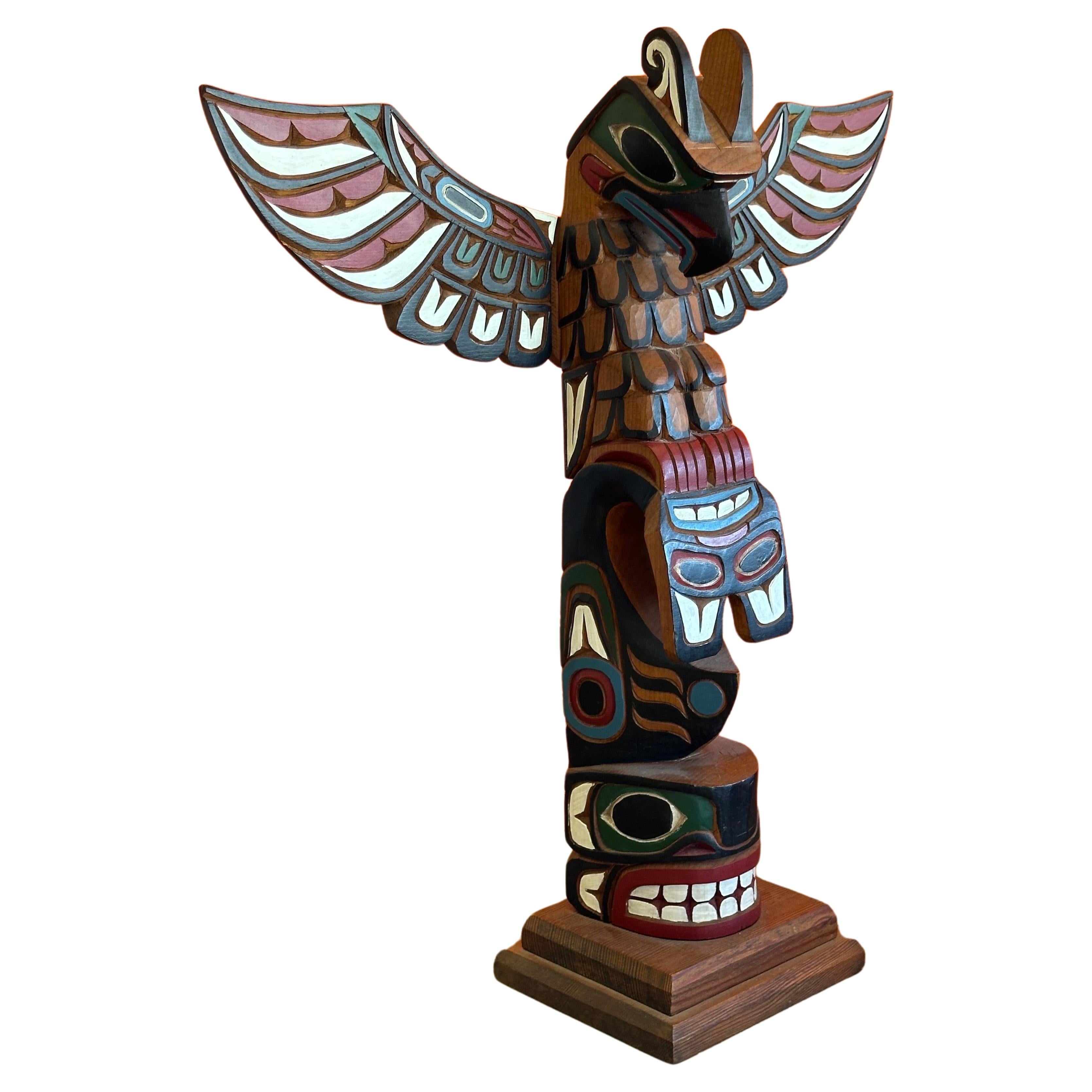 A fine example of a Salish northwest coast American Indian hand carved wood totem pole by master carver Gary Rice, circa 1980s. The Totem stands and 19.5