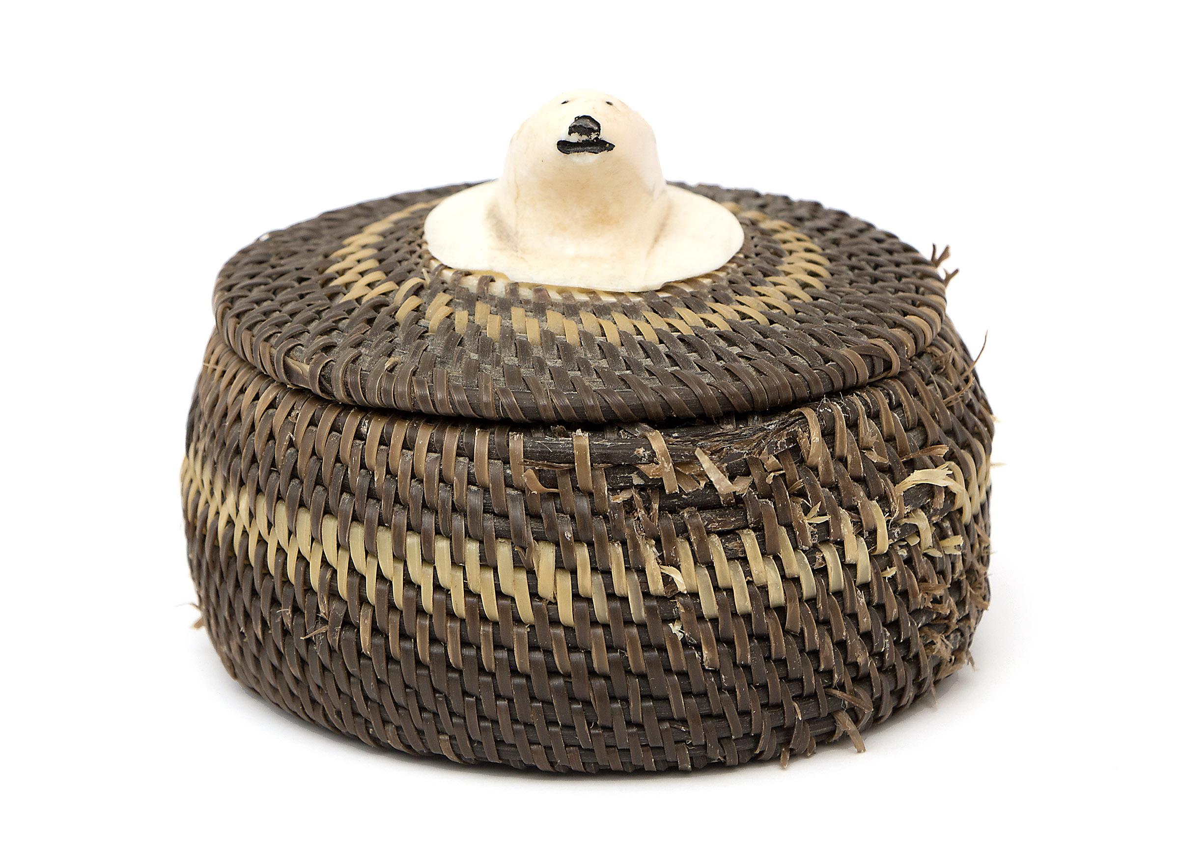 Eskimo woven baleen basket with a carved polar bear head finial by Native American Northwest Coast artist, Joe Sikvayugak (1898-1983), Inupiaq (Alaskan Inupiat Eskimo).