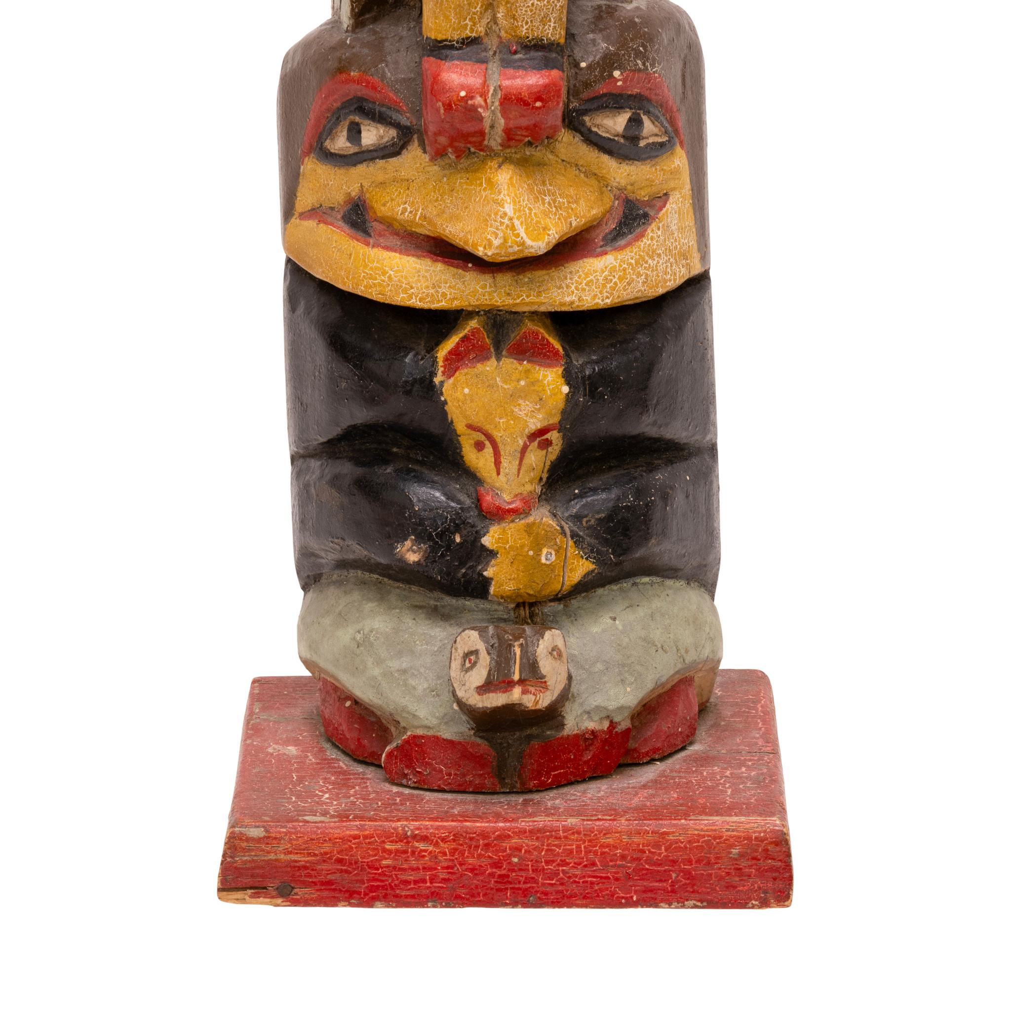Northwest Coast polychrome totem with multiple bird figures atop a turtle. Hole drilled for clamp. Well painted and carved with bright colors of red, black, blue, white, and brown on painted red base. Would display nicely in a handmade indigenous
