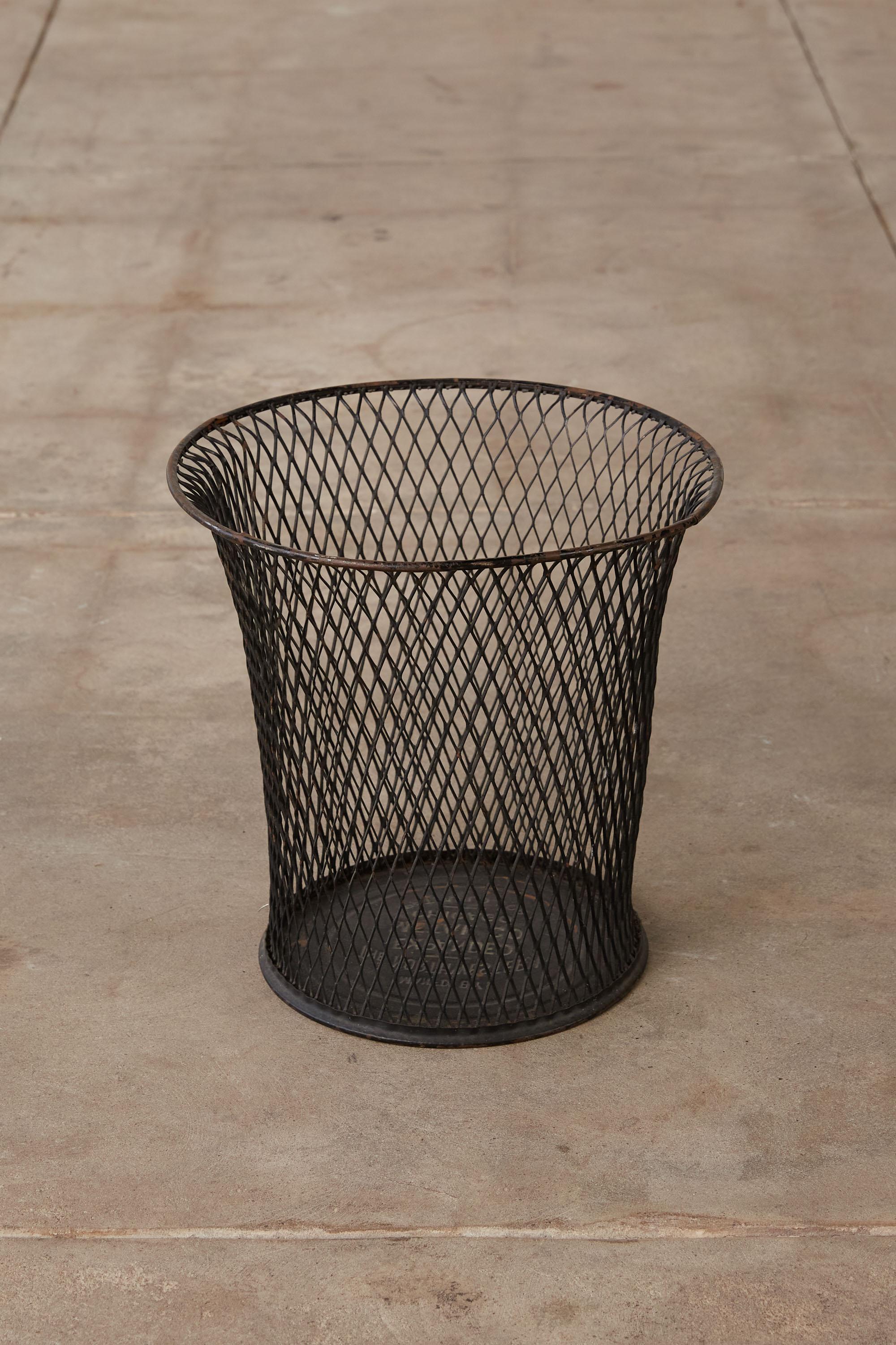 A wire mesh waste basket by Northwestern Expanded Metal Company, Chicago, c. 1930's. This piece is a staple of any midcentury office, holds all of your office waste and is stylish while doing so. It features an expanded metal body an elegantly