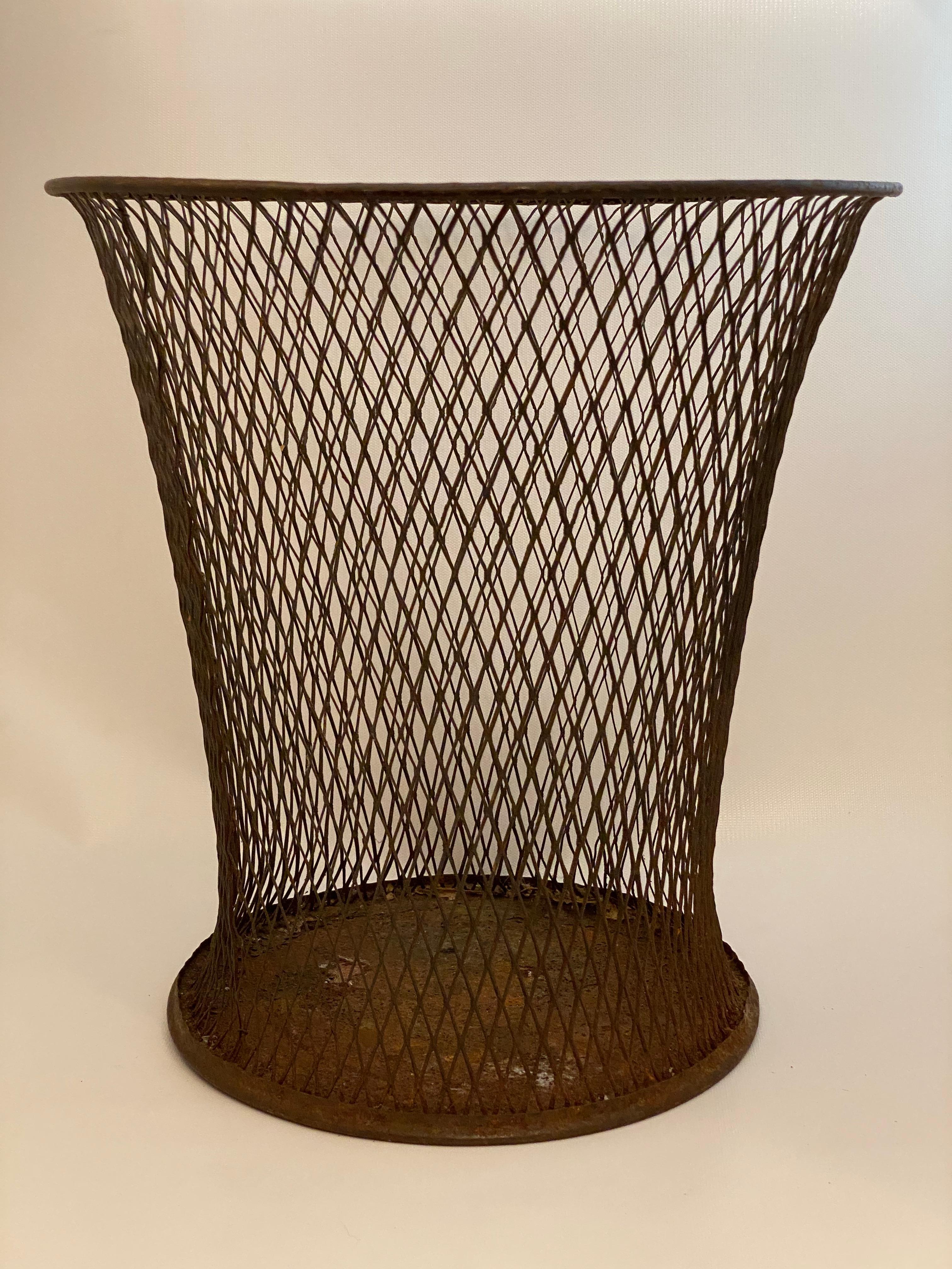 The Northwestern Expanded Metal Company, Chicago wire mesh waste basket. Fantastic diamond mesh pattern with an elegantly flared lines. Fully stamped signature on the underside. Circa 1920-30. Good overall condition with some rusting and pitting.