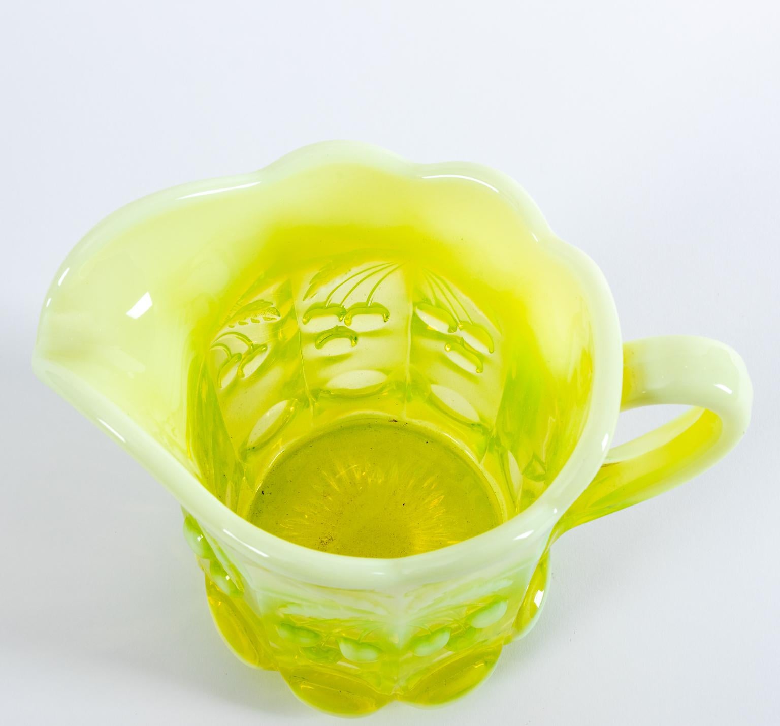 Northwood glass pitcher opalescent, vaseline,custard glass with cherries motif, circa 1900s. Made in the United States. Please note of wear consistent with age.