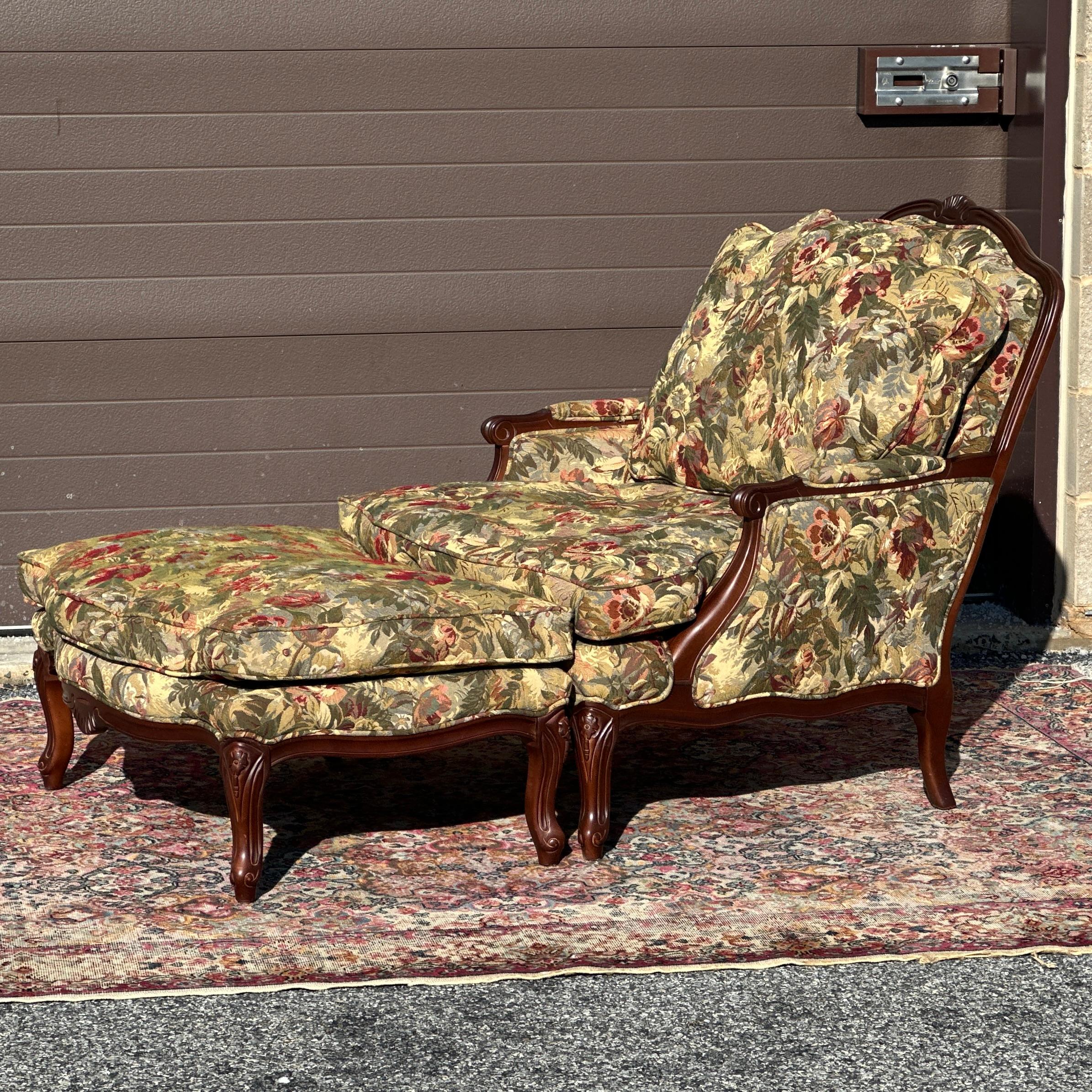 Vintage French style bergere chair & ottoman set handcrafted in USA by Norwalk Furniture with feather cushions and original floral tapestry upholstery.

Ottoman 33”w x 24”d x 16”h
