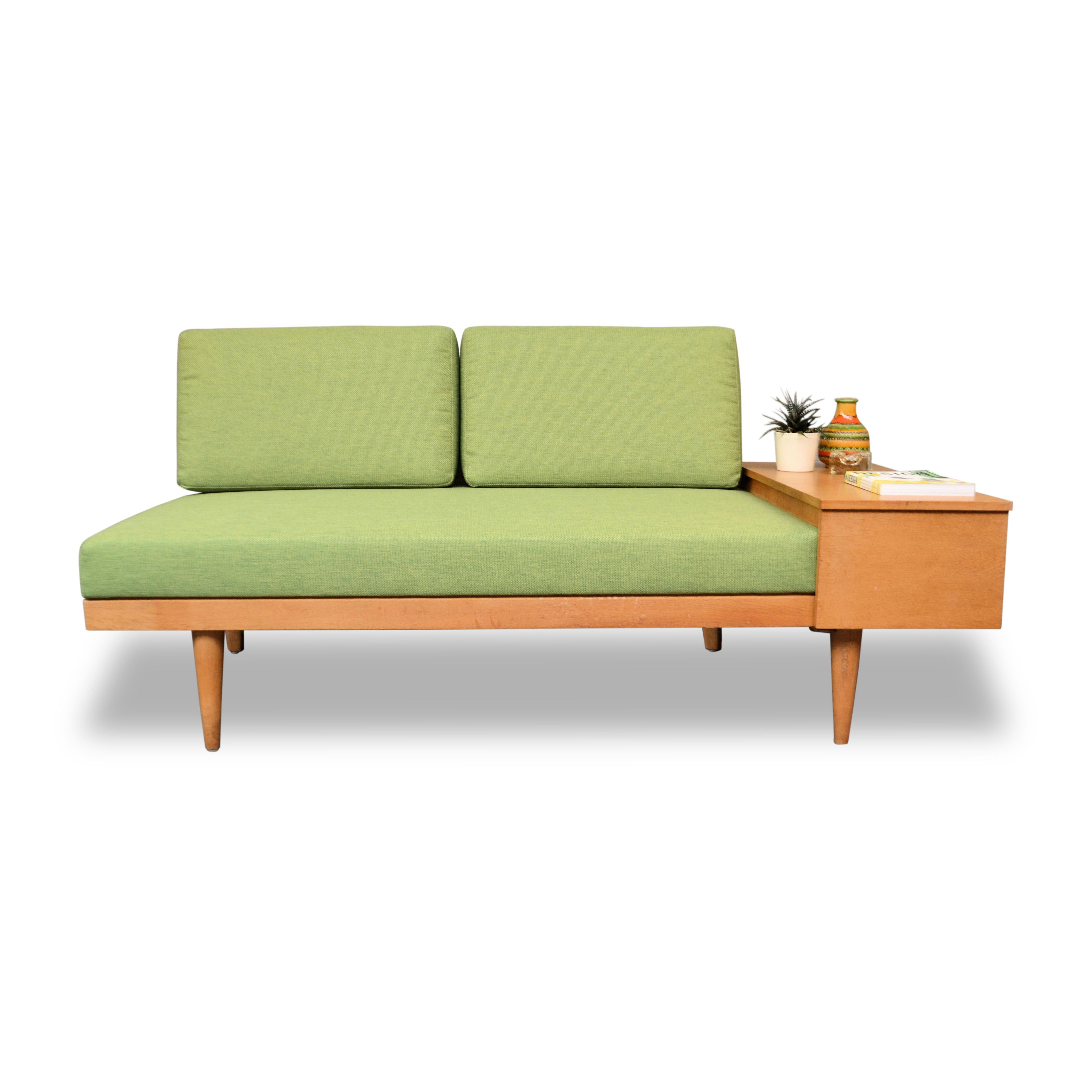 Vintage Norwegian oak seating two-seater sofa/daybed, model “Svanette” designed by Ilmar Relling & Haldor Vik for Ekornes Svane. This model stylish two-seater can easily be transformed into a guest bed, by just opening the tabletop and placing one