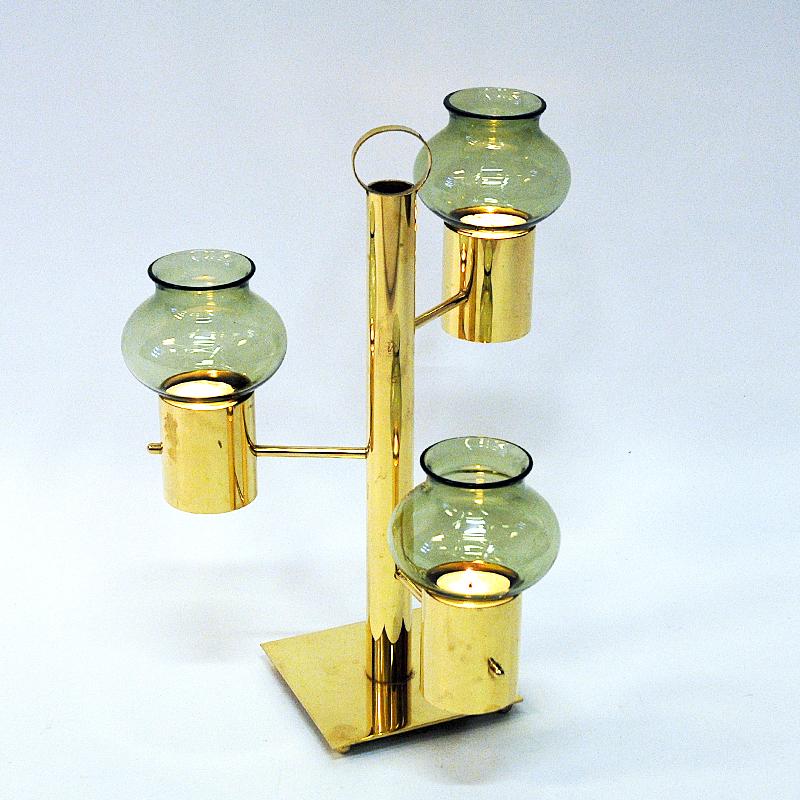 Mid-century Norwegian brass candle holder with light green glass shades placed on three levels - by Colseth Norway 1960s. Oval shaped and removable glass shades. The candle holder has a handle on top which makes it easy to move around even when the
