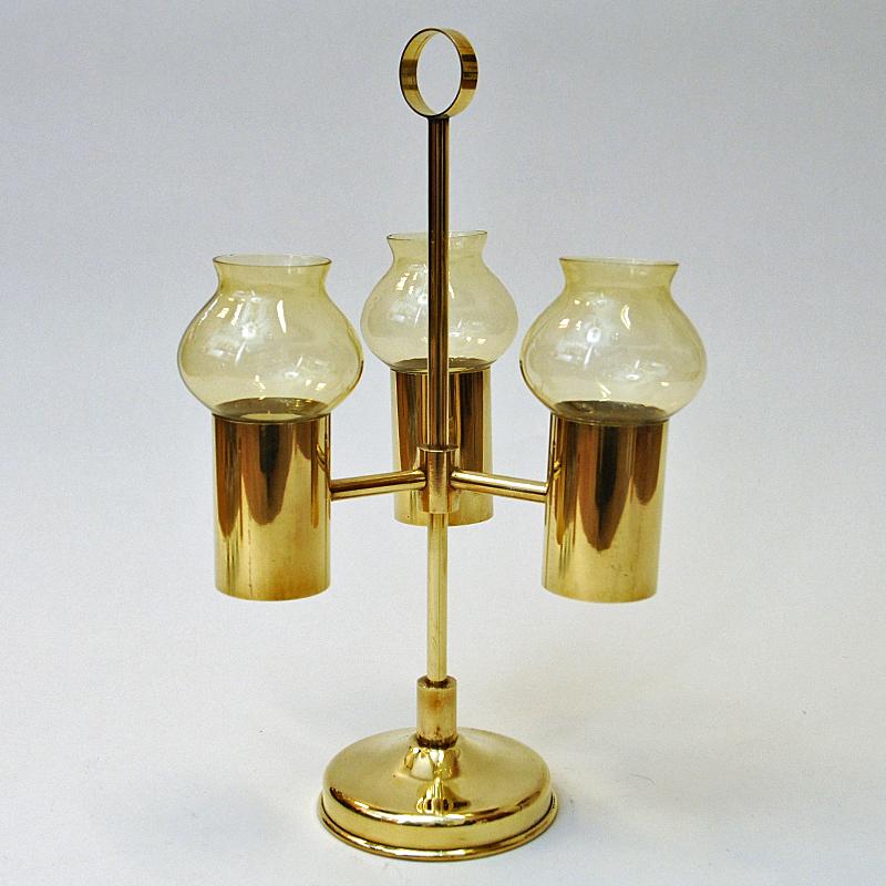 Mid-century brass candle holder with amber colored glass shades by Odel Messing, Norway 1960s. Beautifully tulip shaped and removable glass shades. You can also use the candle holder without the shades if you wish. The holder also has a handle on