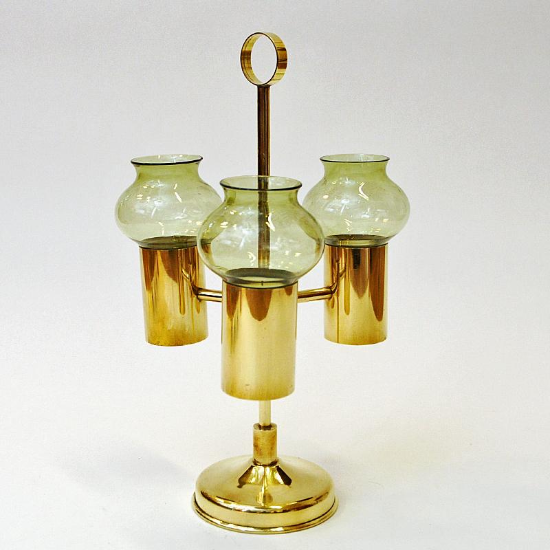 Mid-century brass candle holder with light green colored glass shades by Odel Messing, Norway 1960s. Beautifully tulip shaped and removable glass shades. You can also use the candle holder without the shades if you wish. The holder also has a handle