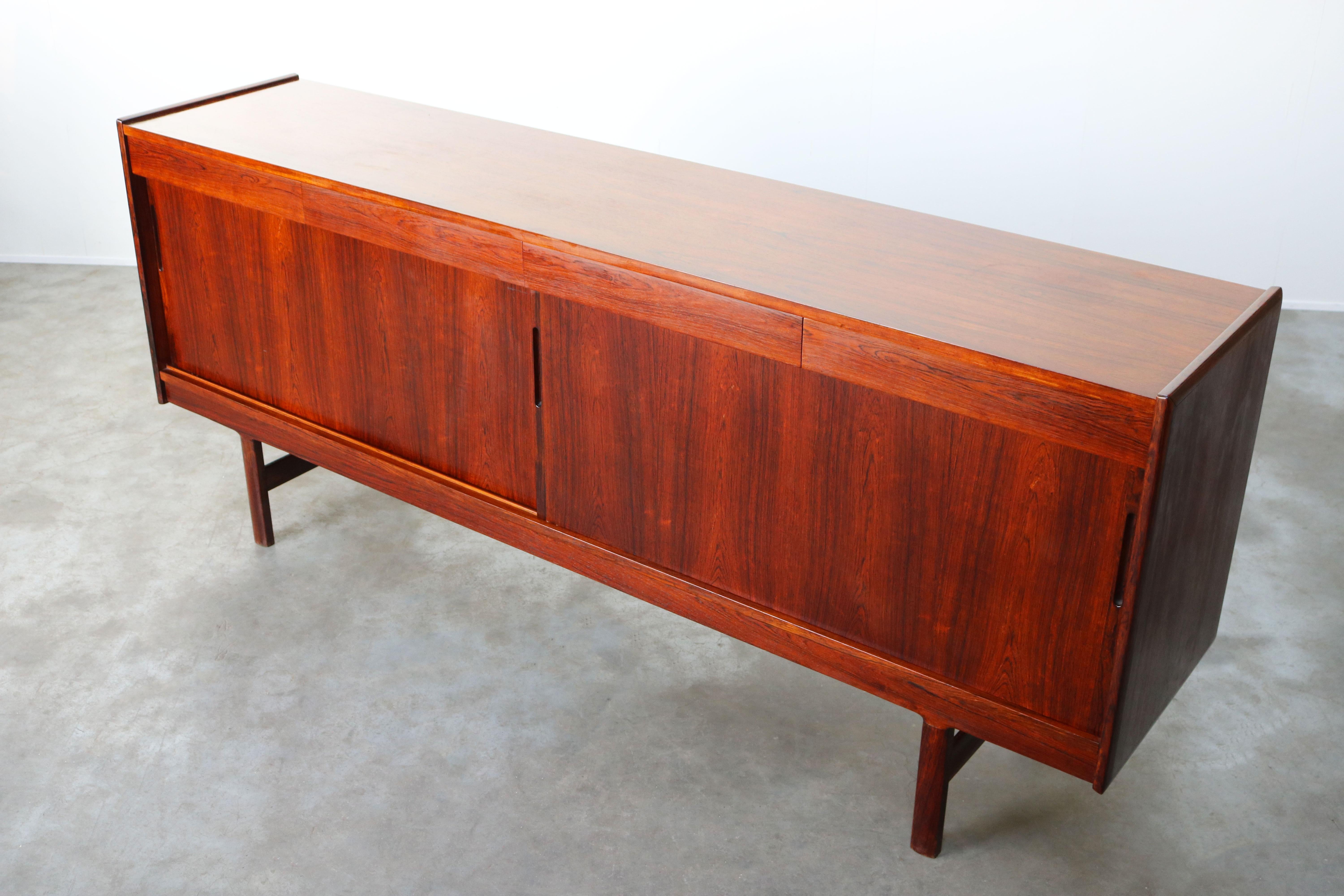 Wonderful design sideboard / credenza from Norway produced and designed by the Westnofa Furniture Company in the 1950s. The sideboard has a wonderful Minimalist modern design with 4 hidden drawers and 2 large sliding doors. The sideboard is made