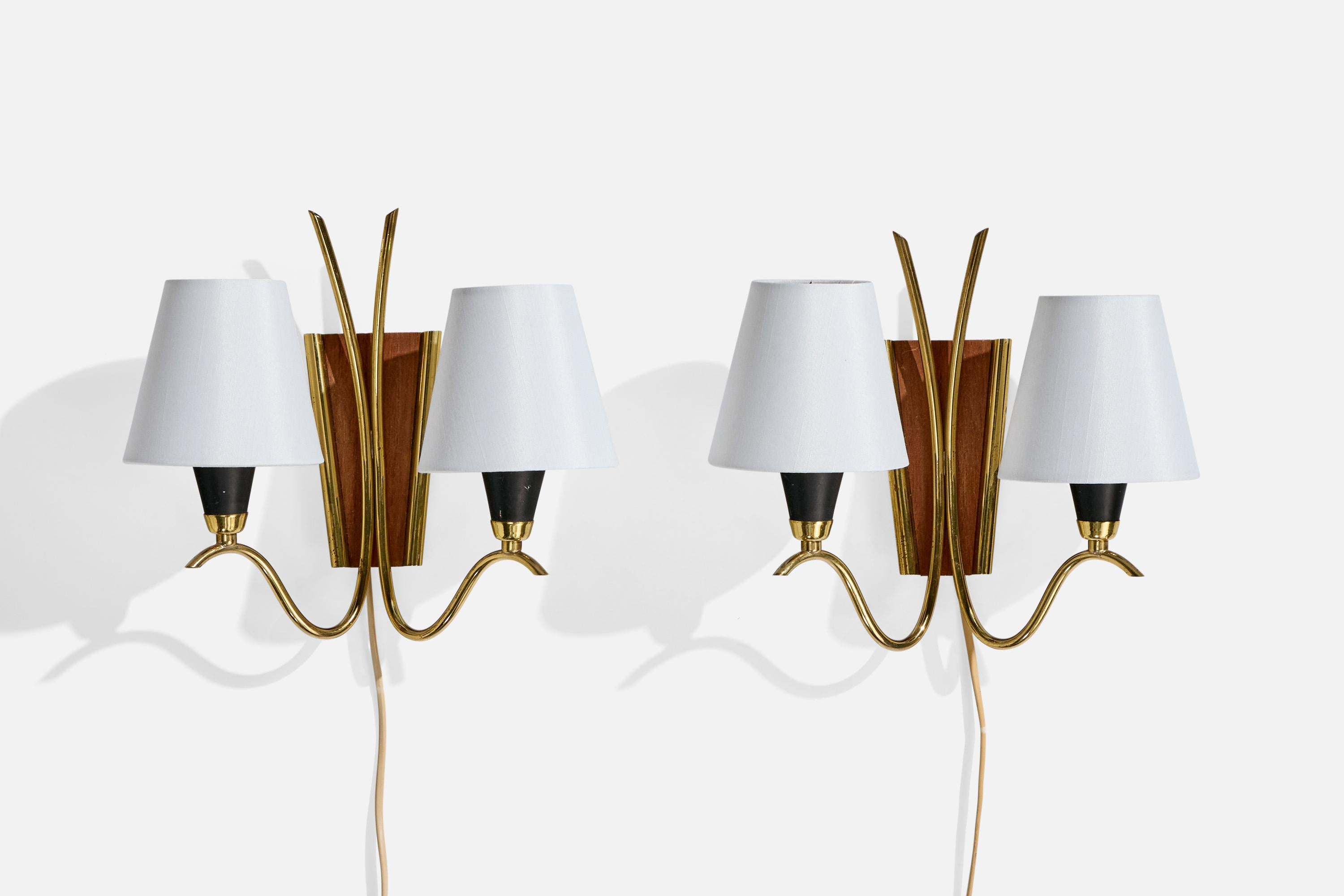 A pair of black-lacquered metal, brass, teak and white fabric wall lights designed and produced in Norway, c. 1950s.

Overall Dimensions (Inches): 10.75” H x 12” W x 6.25“ D

Back Plate Dimensions (Inches): 2.4” H x 2.4” W x .75” D

Bulb