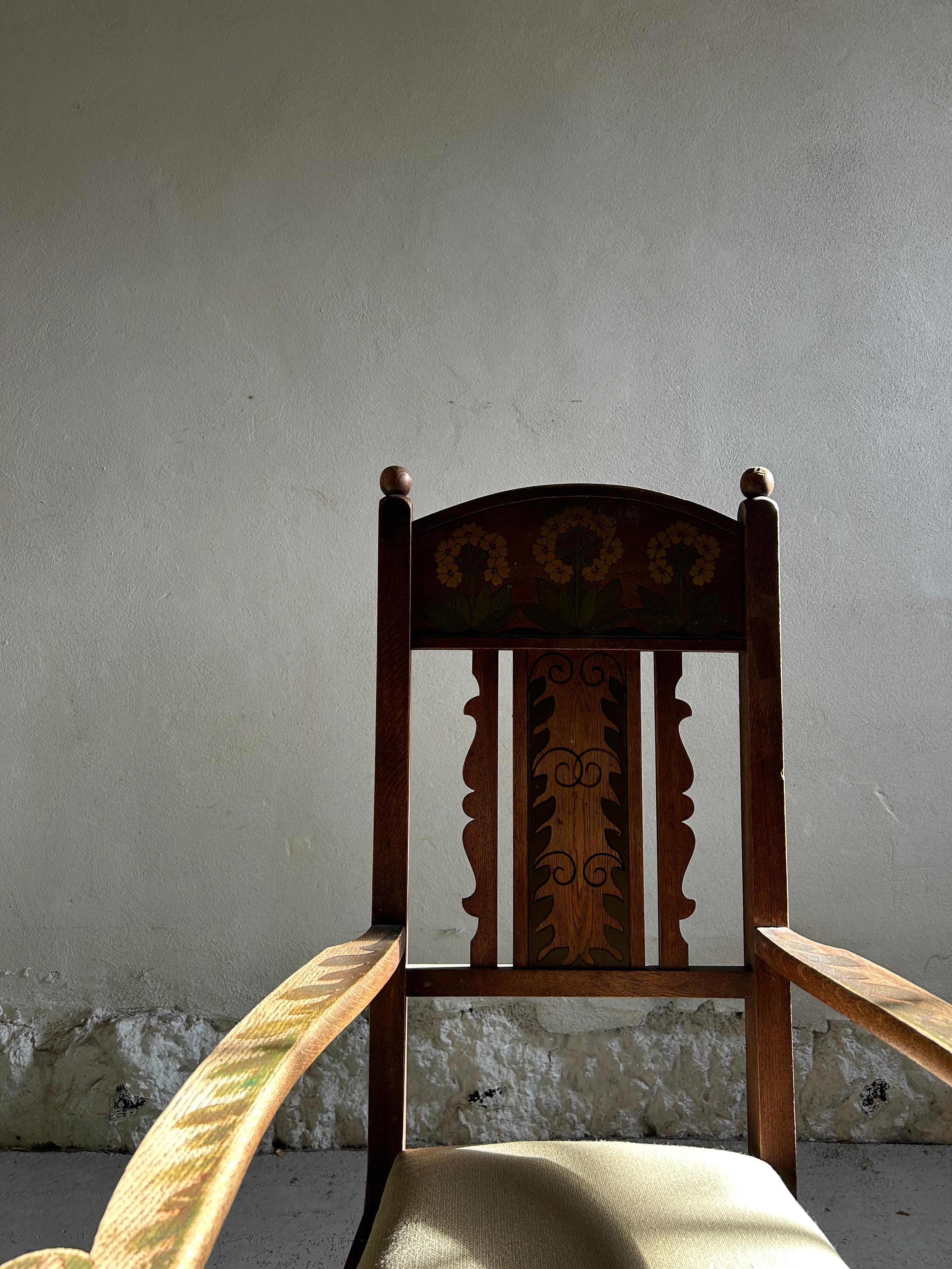 This captivating Norwegian folk art armchair, crafted in oak during the 1880s, exemplifies the rich tradition of Scandinavian craftsmanship. The chair features its original painted floral decorations on the backrest and armrests, showcasing