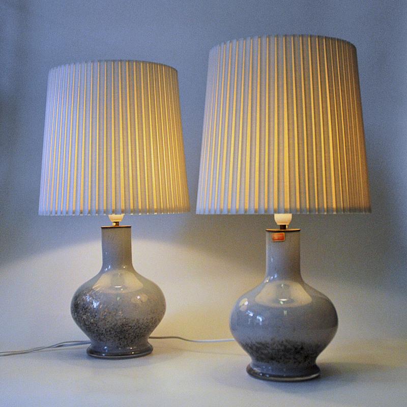 ﻿Lovely pair of handblown art glass tablelamps designed by Torbjørn Torgersen for Randsfjord Glassverk Norway, 1970s. These precious egg shaped lamps have a light grey glazed glass base with speckled darker grey colors on the lower part combined