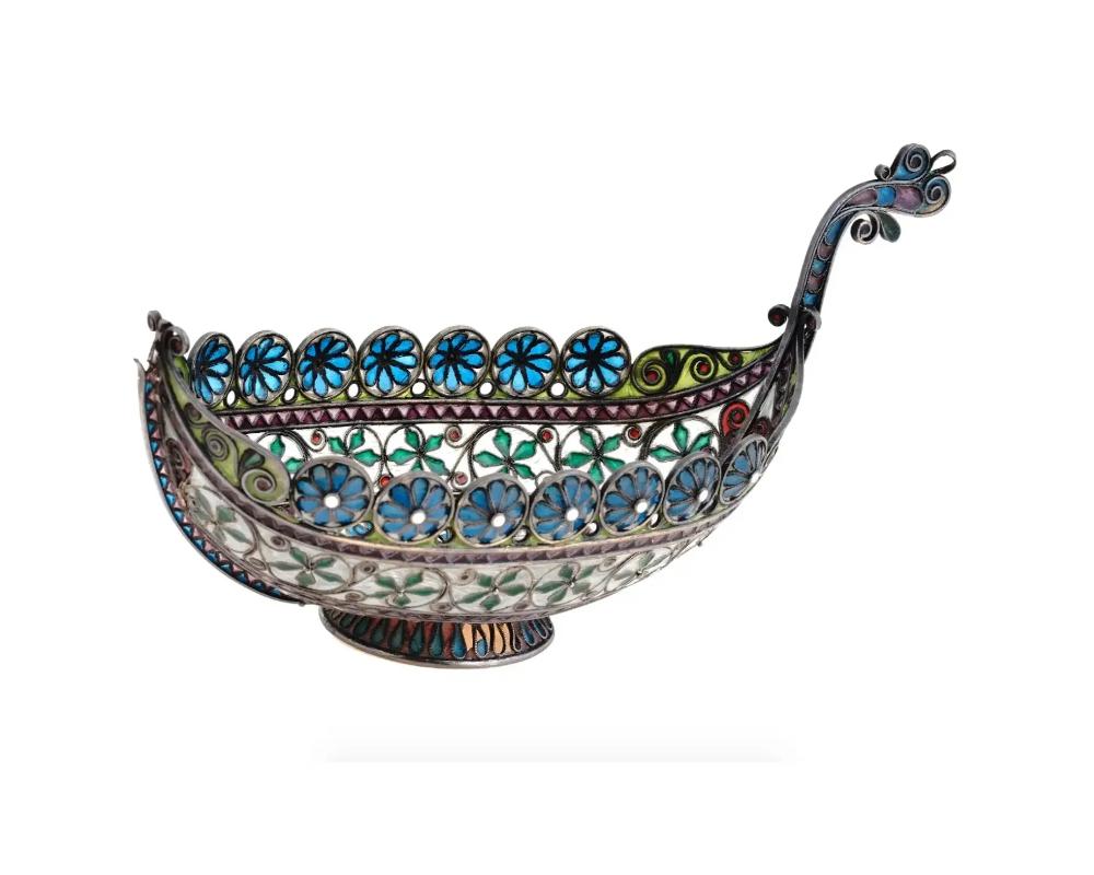 An antique Norwegian 930 silver gilt salt cellar modeled as a Viking ship decorated with exquisite plique a jour enamel patterns by Marius Hammer. The plique a jour enamel is a technique in which the enamel is applied to the membranes in a thin