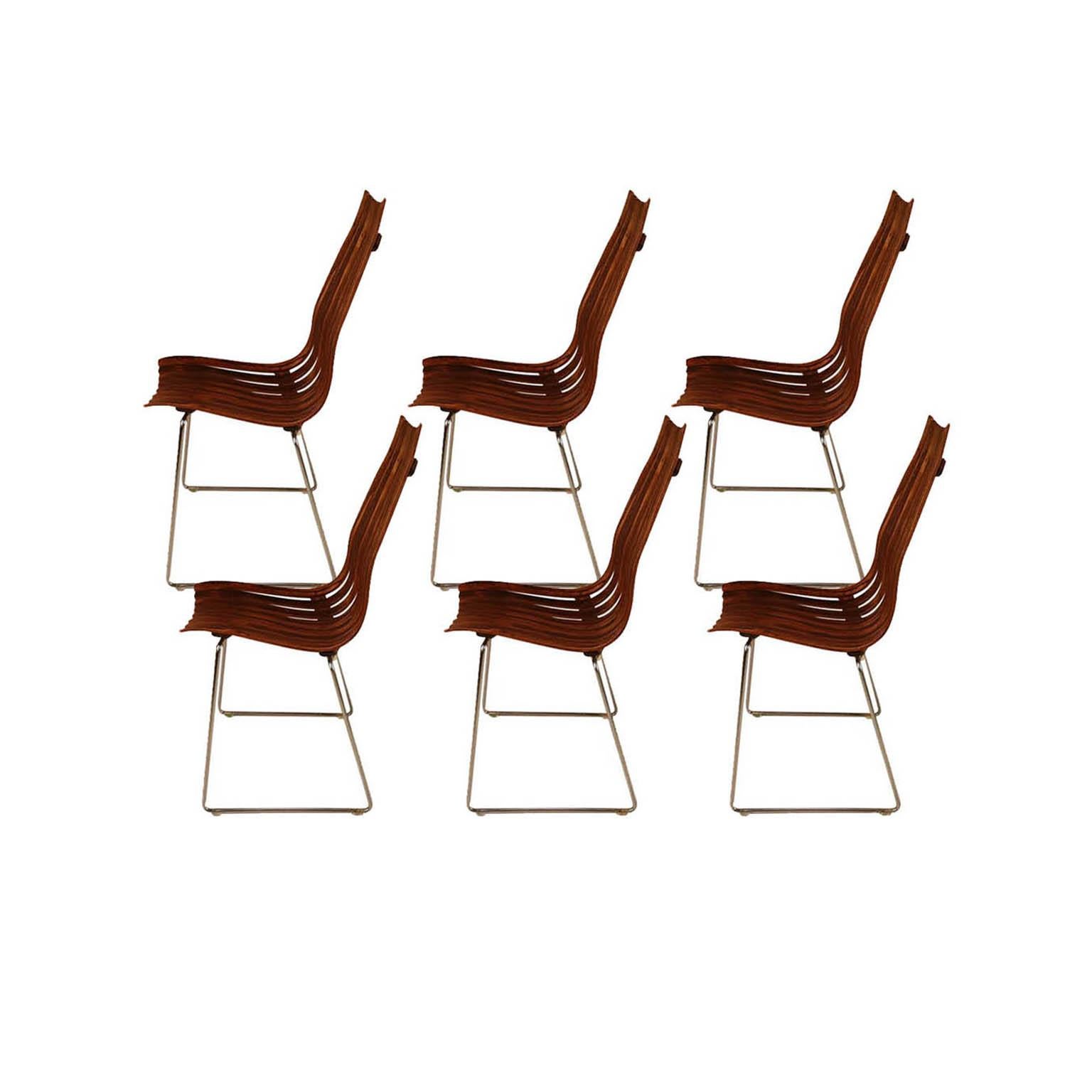 A rare set of six stunning midcentury, modern, stackable, high back, rosewood, senior, dining chairs part of the “Scandia” series, designed by Hans Brattrud for Hove Møbler, Norway, circa 1957. One of the most unique designs to come from the