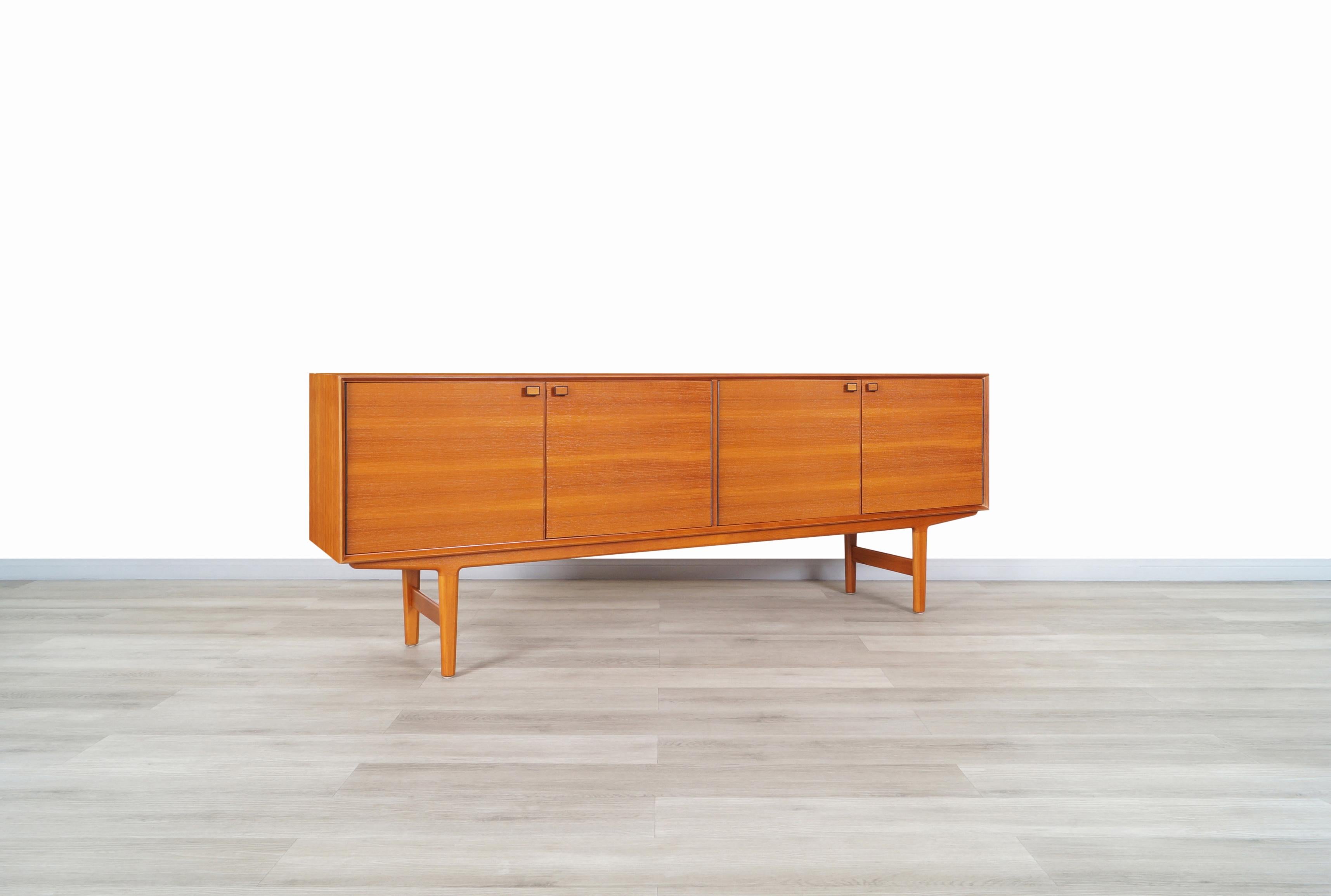 Stunning Norwegian modern teak credenza designed by Fredrik Kayser and manufactured by Viken Mobelfabrik in Norway, circa 1960s. Features a wide case where you can see the Fine grains of teak through the structure. In the front, we have four doors