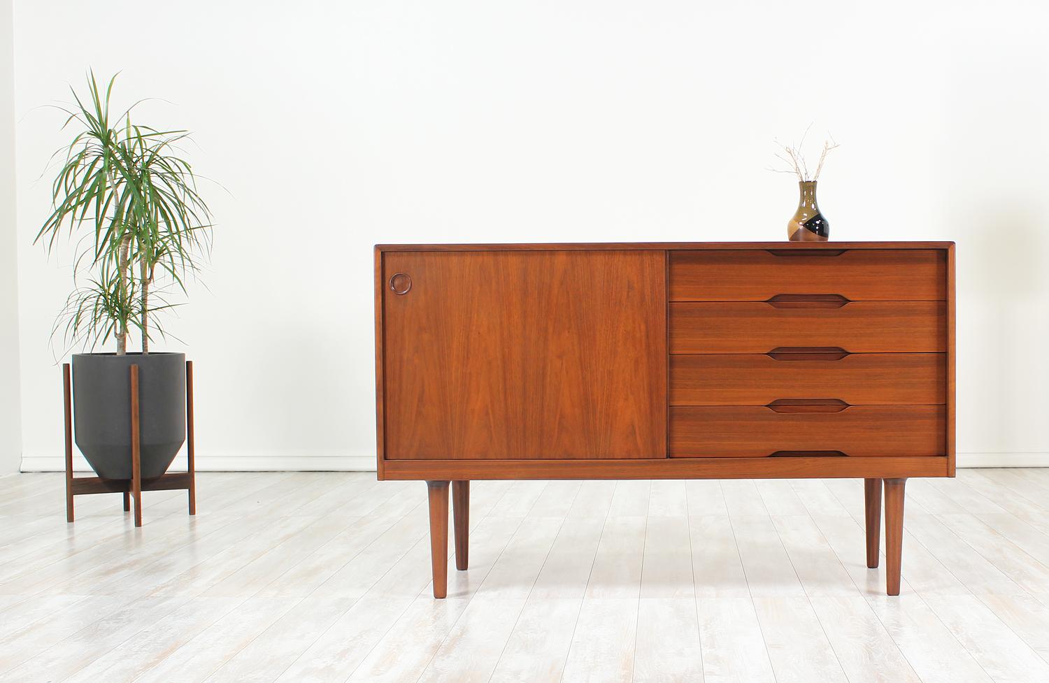 Beautiful credenza designed and manufactured by Gustav Bahus in Norway circa 1960. A versatile and elegant Scandinavian modern design that has been sturdily constructed in rich walnut wood to provide plentiful storage with organic contours and clean