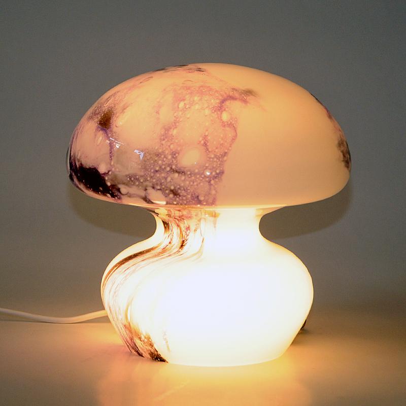 ﻿Lovely and completely decorative and special glass tablelamp designed by Torbjørn Torgersen for Randsfjord Glassverk Norway, 1970s. A mushroom shaped opaline glass lamp with random purple and lilac colors in floating patterns. White cord with light