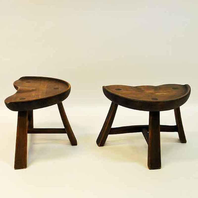 Gorgeous and attractive dark pair of pine stools with very nice patina produced by Norwegian furniture company Krogenæs Møbler in the 1970s. Wide and open sculpted seats with tractorseat design. Decorative wooden plugs. Name of producer is