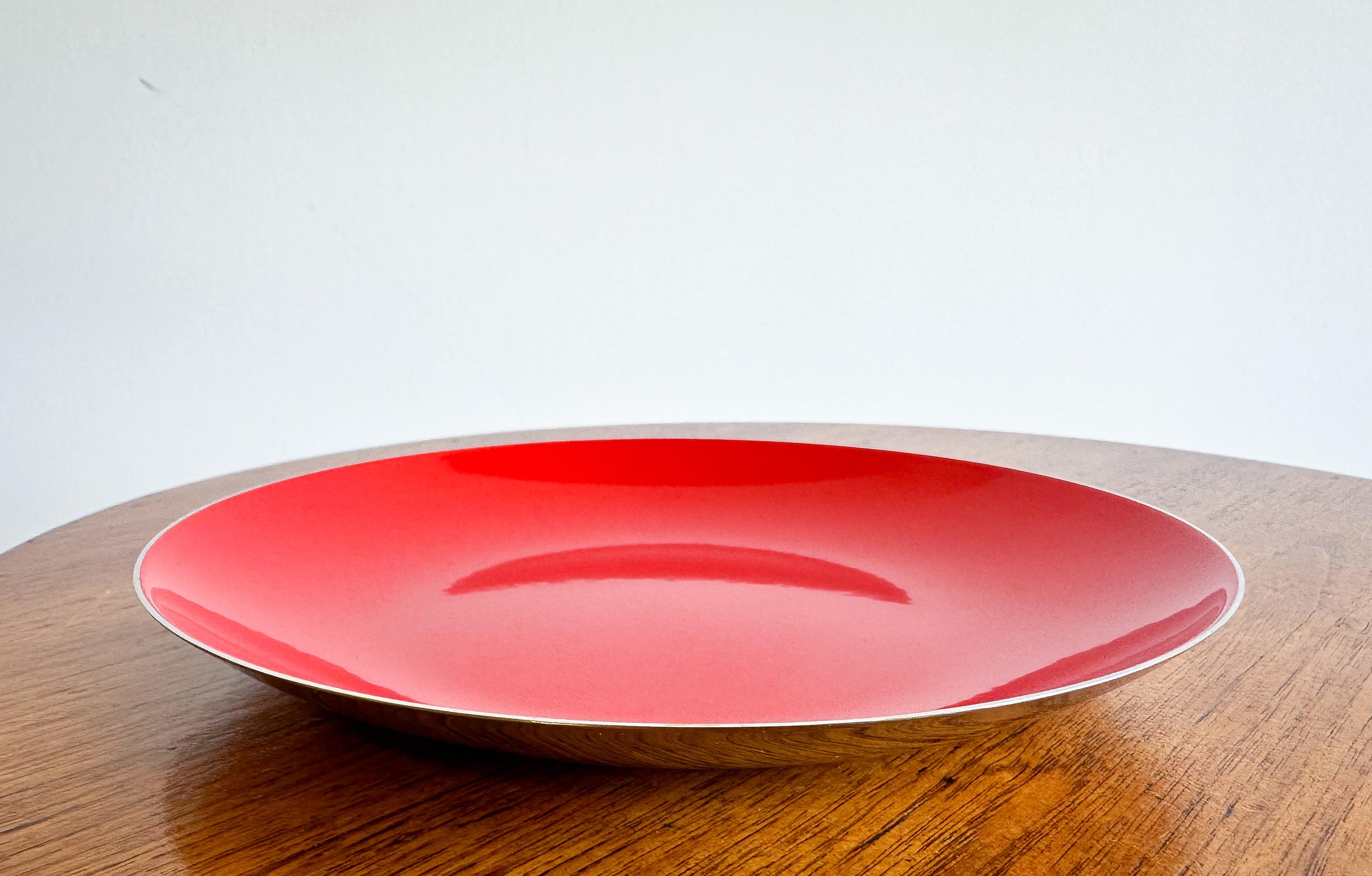 A red enameled stainless steel decorative dish/bowl produced by Leif Wessman Associates of Norway. Distributed by Knoll International.

Use anywhere for a fun pop of color.