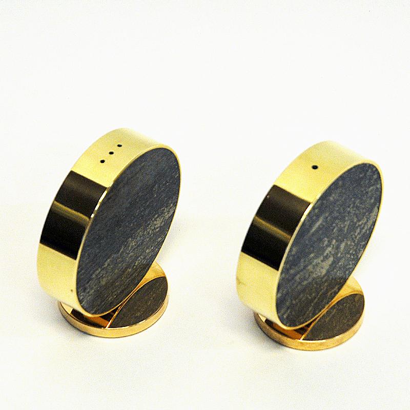 Stylish and decorative Norwegian brass and stone shakers for salt and pepper. They have a black padded fabric base with label underneath but text is worn away.
A Norwegian product from the 1970`s with beautiful polished stone and brass around.
