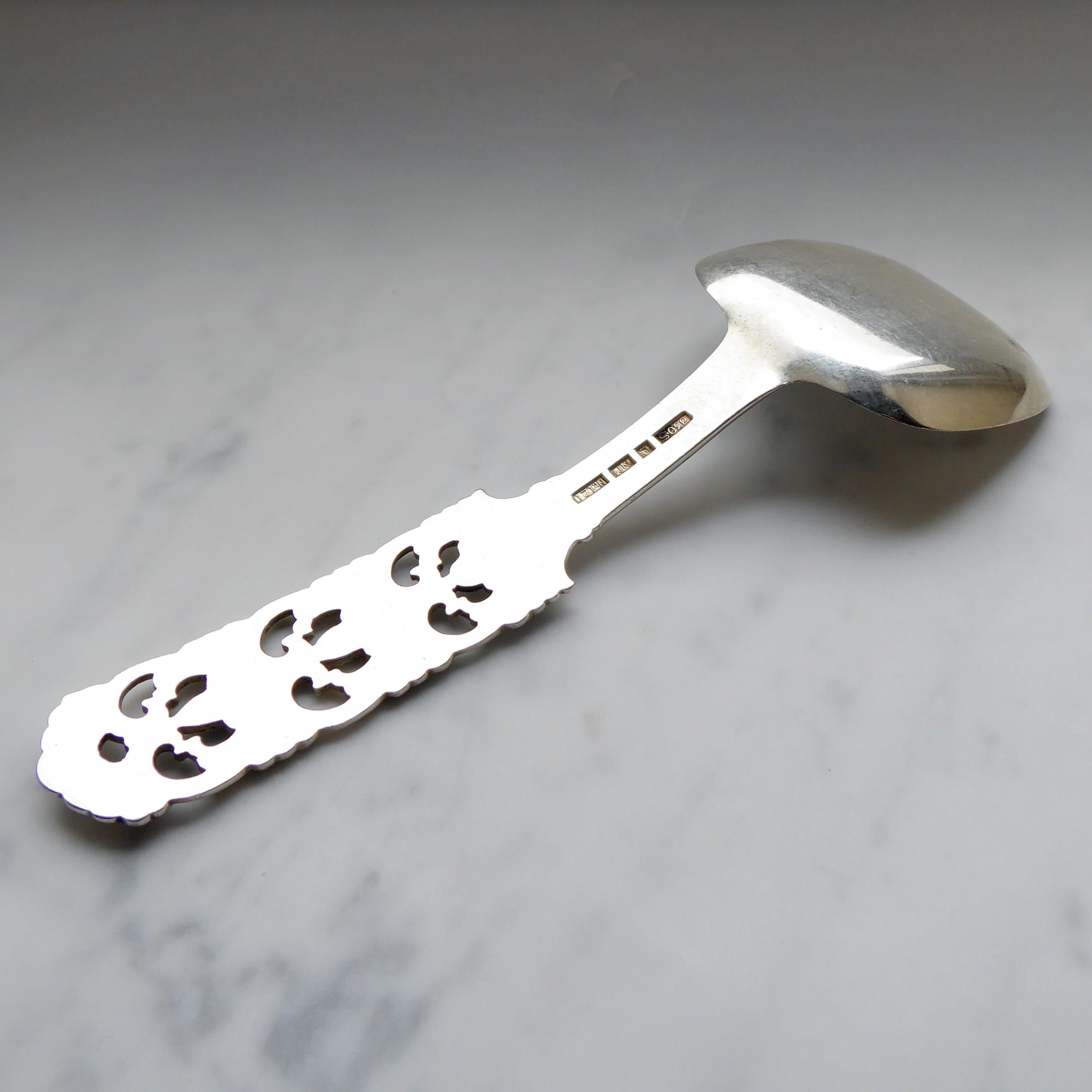 A vintage Norwegian silver spoon by Brodrene Lohne,  the handle is decorated with a pineaplie pierced motif known as the Kloster pattern.  Measuring approximately 5.75 inches long the spoon is an attractive rounded corner square shape approx. 1.94