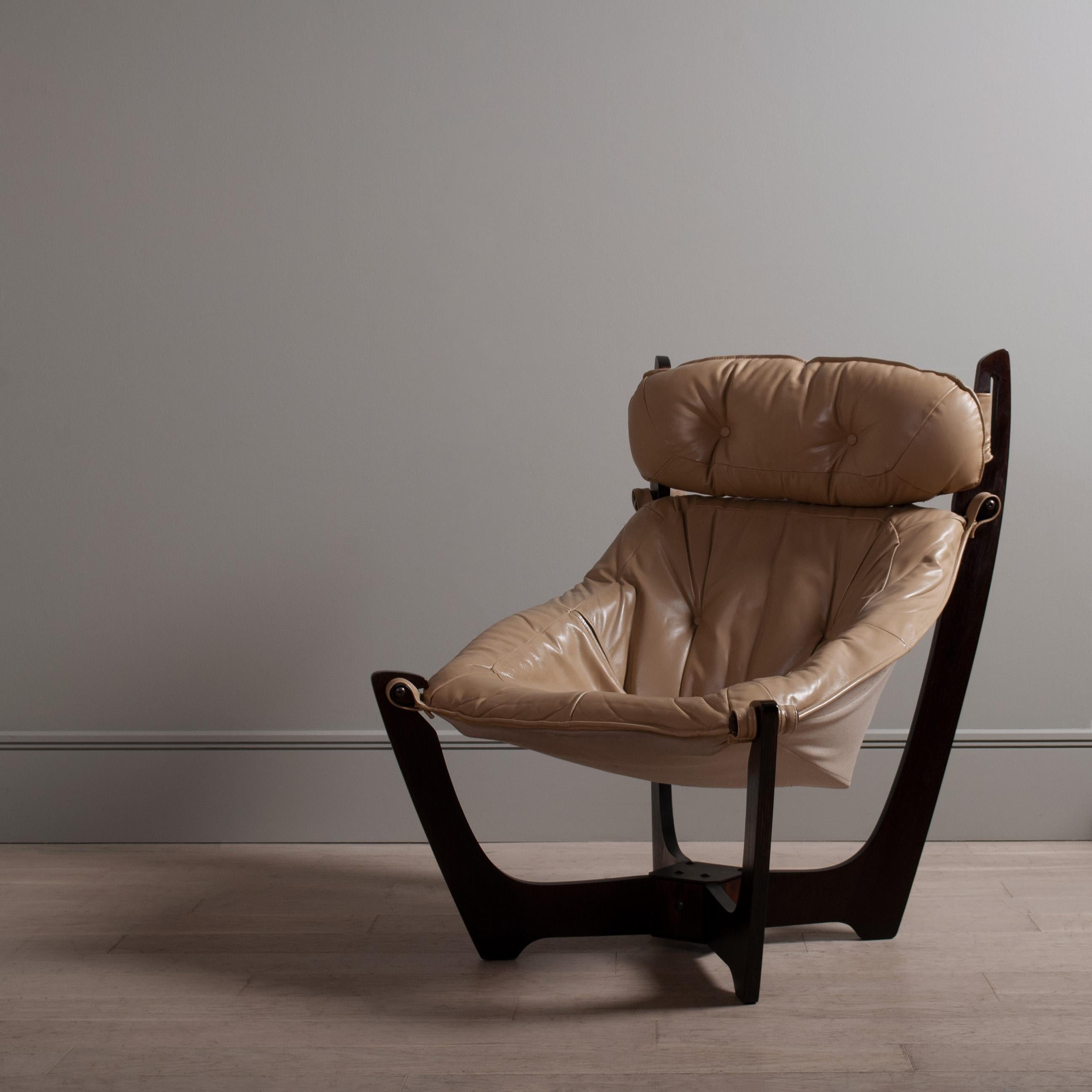 Incredible space age lounge chair by Norwegian designer Odd Knutsen. The Luna chair is a wonderful and unique design that suspends the sitter within the wooden frame. A genius and complex design. The upholstery is leather and the frame a dark