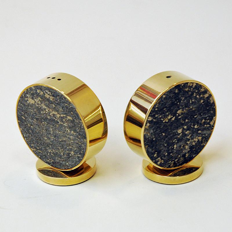 Stylish and decorative Norwegian brass and stone shakers set for salt and pepper. They have a green padded fabric base with label underneath but text is worn away.
A Norwegian product from the 1970's with beautiful polished stone and brass around.
