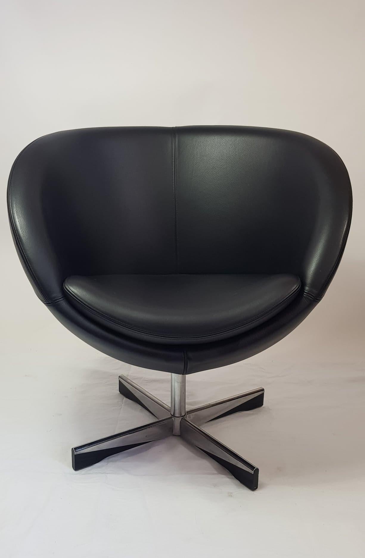 Designed by Sven Ivar Dysthe and manufactured by Stokke in Norway. The planet has now become an icon of Scandinavian design. The black leather upholstery covering the spheroidal seat and padded arms, as well as a removable seat cushion is of a high