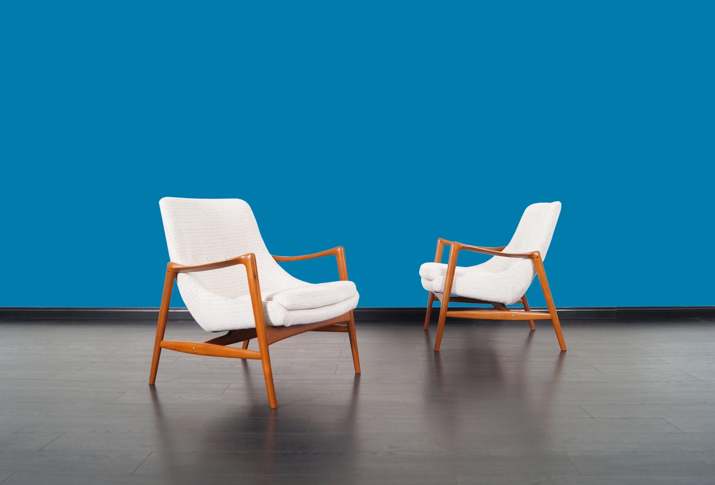 Pair of stunning Norwegian teak lounge chairs designed by Rolf Rastad and Adolf Relling for Bokka Møbler. Features solid teak frames and professionally reupholstered in custom chenille fabric.