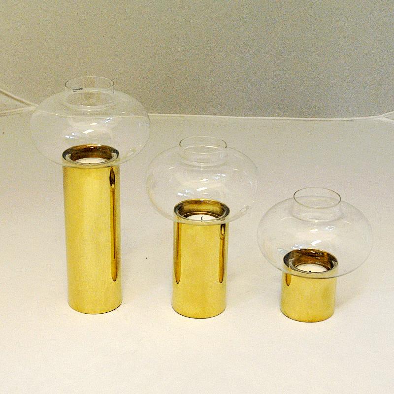 A lovely vintage set of three Norwegian brass cylinder candle holders of different heights made by Colseth Norway in the 1960s. With an oval shaped clear colored glass shade by Orrefors, Sweden. Removable glasses - so the candle lights may also we