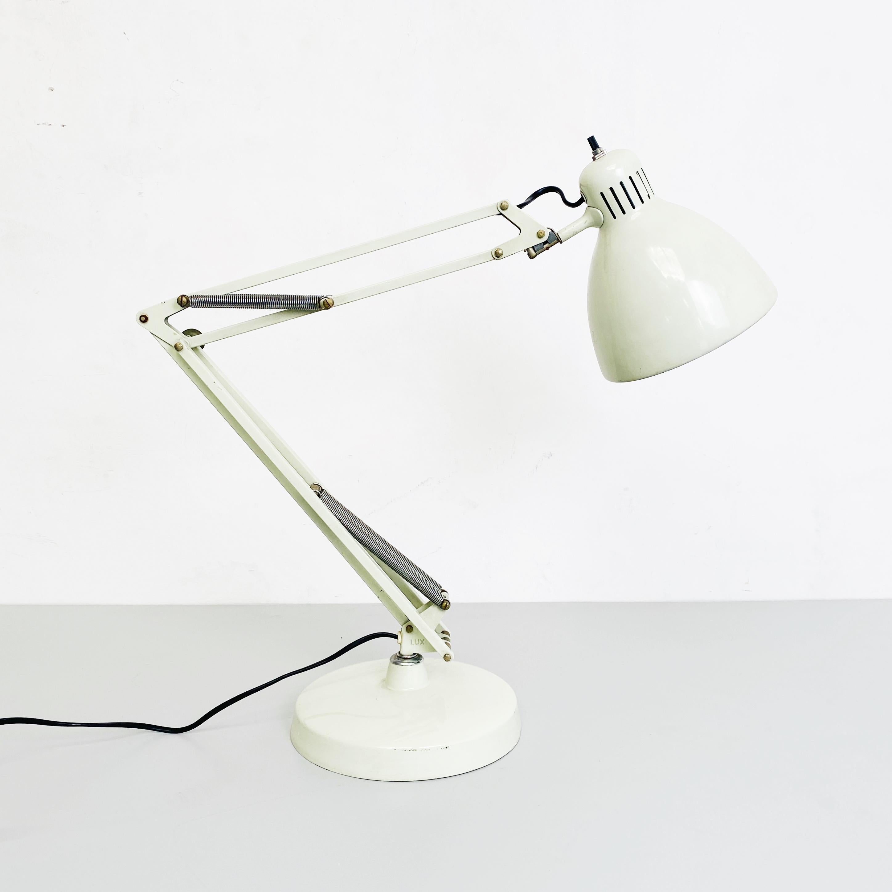 Norwegian white metal Naska Loris table lamp by Jac Jacobsen for Luxo, 1950s
Adjustable table lamp Naska Loris, in white enamelled metal with round base with structure and lampshade adjustable in any position. 
Produced by Luxo in 1950s. but