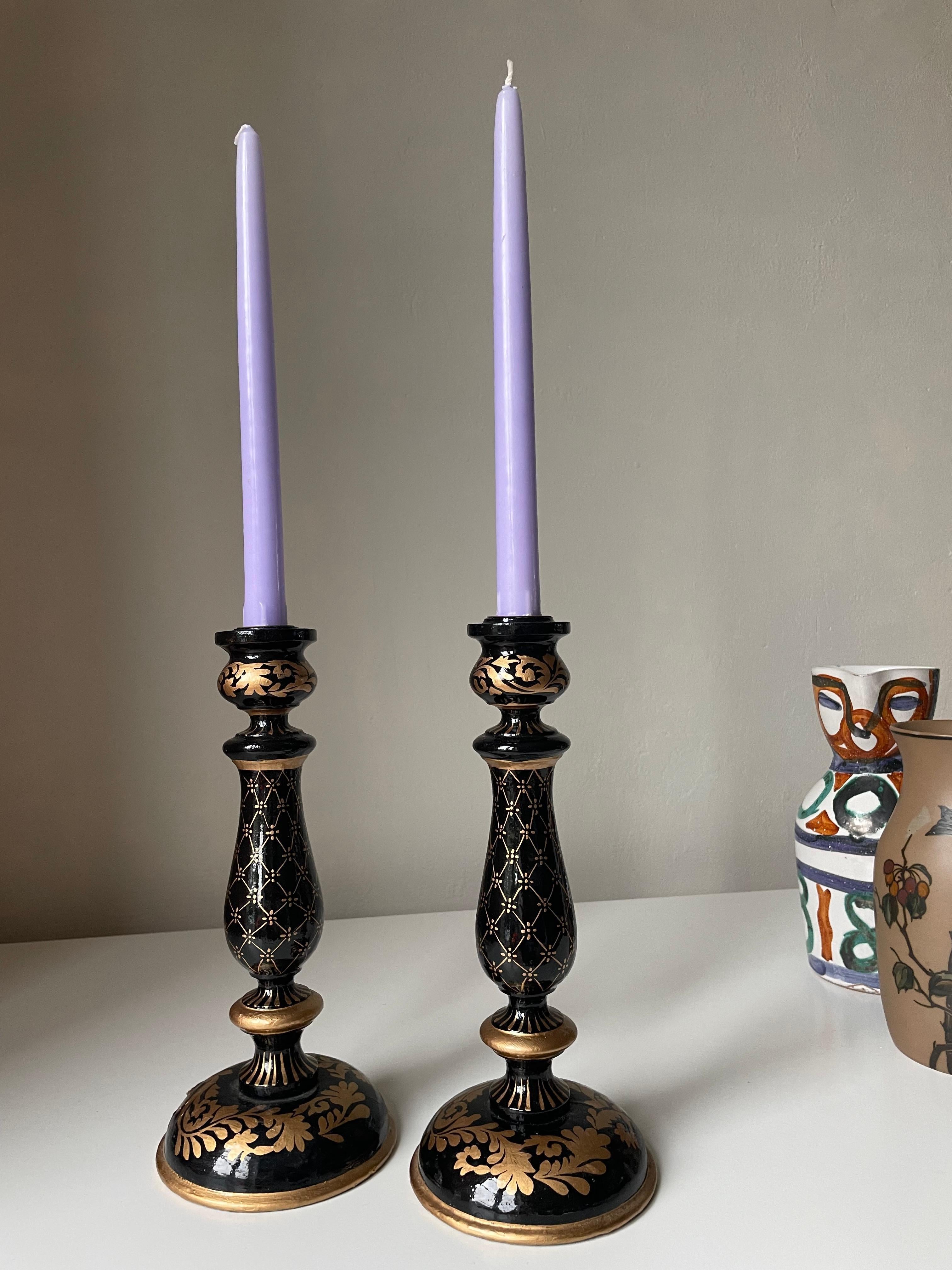 Set of vintage Norwegian wooden candle sticks with black and gold paint in intricate organic patterns. Beautiful vintage condition. 
Norway, 1970s. 