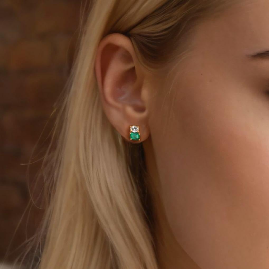 The Nostalgic Emerald 14K Yellow Gold Diamond Stud Earrings capture the essence of timeless elegance with their stunning combination of natural diamonds and emeralds. Set in 14K yellow gold, these earrings feature emeralds with a deep, vivid green