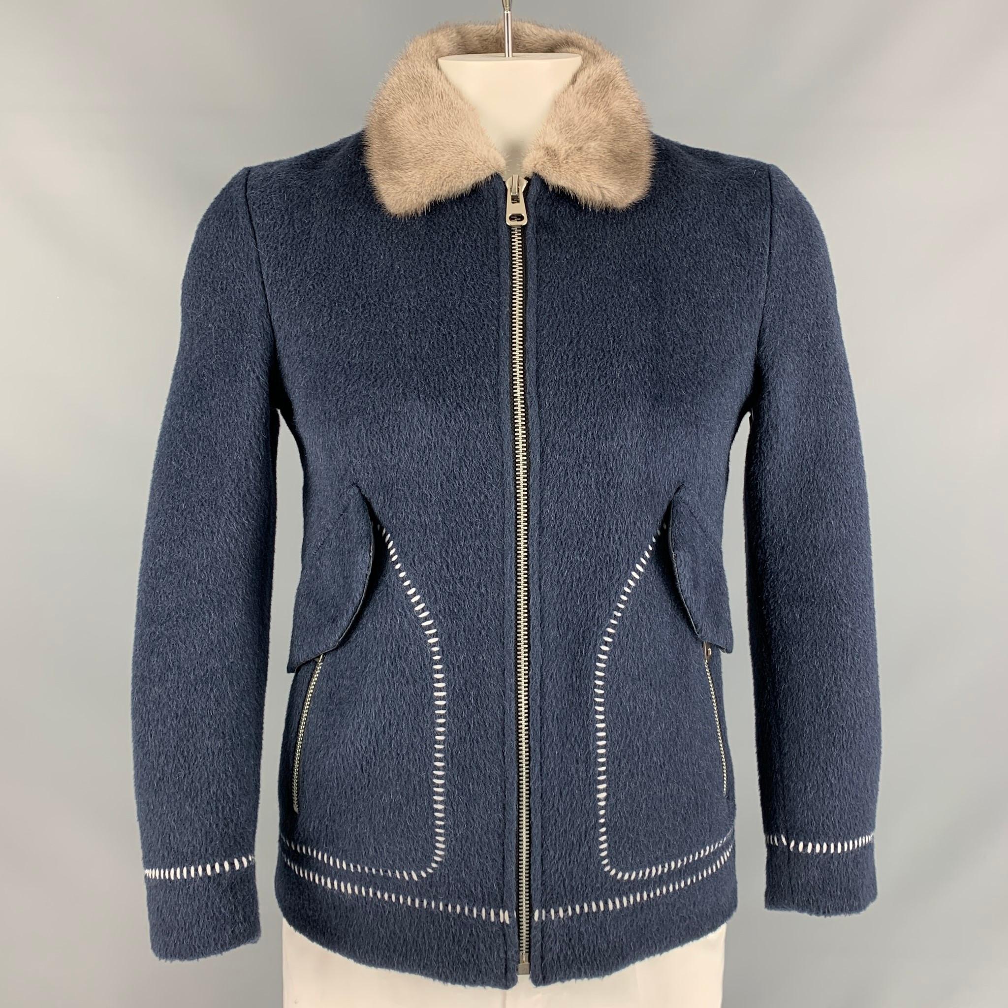 NO BRAND LISTED jacket comes in a navy textured fabric featuring a grey fur collar, two large patch pockets with flap at front and zip up closure. 

Excellent Pre-Owned Condition.
Marked: 3XL

Measurements:

Shoulder: 18 in
Chest: 39 in
Sleeve: 25.5