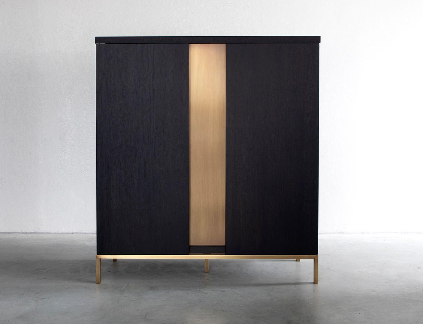 Nota Bene cabinet by Van Rossum
Dimensions: D120 x W50 x H136 cm
Materials: Oak, brass.

The wood is available in all standard Van Rossum colors, or in a matching finish to customer’s own sample.
Detailing is available in stainless steel or